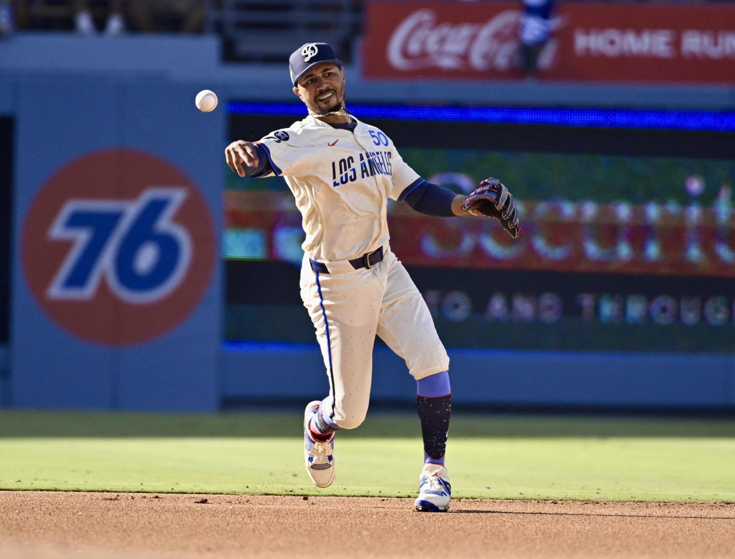 Shortstop Mookie Betts #50 of the Dodgers throws out Christian...