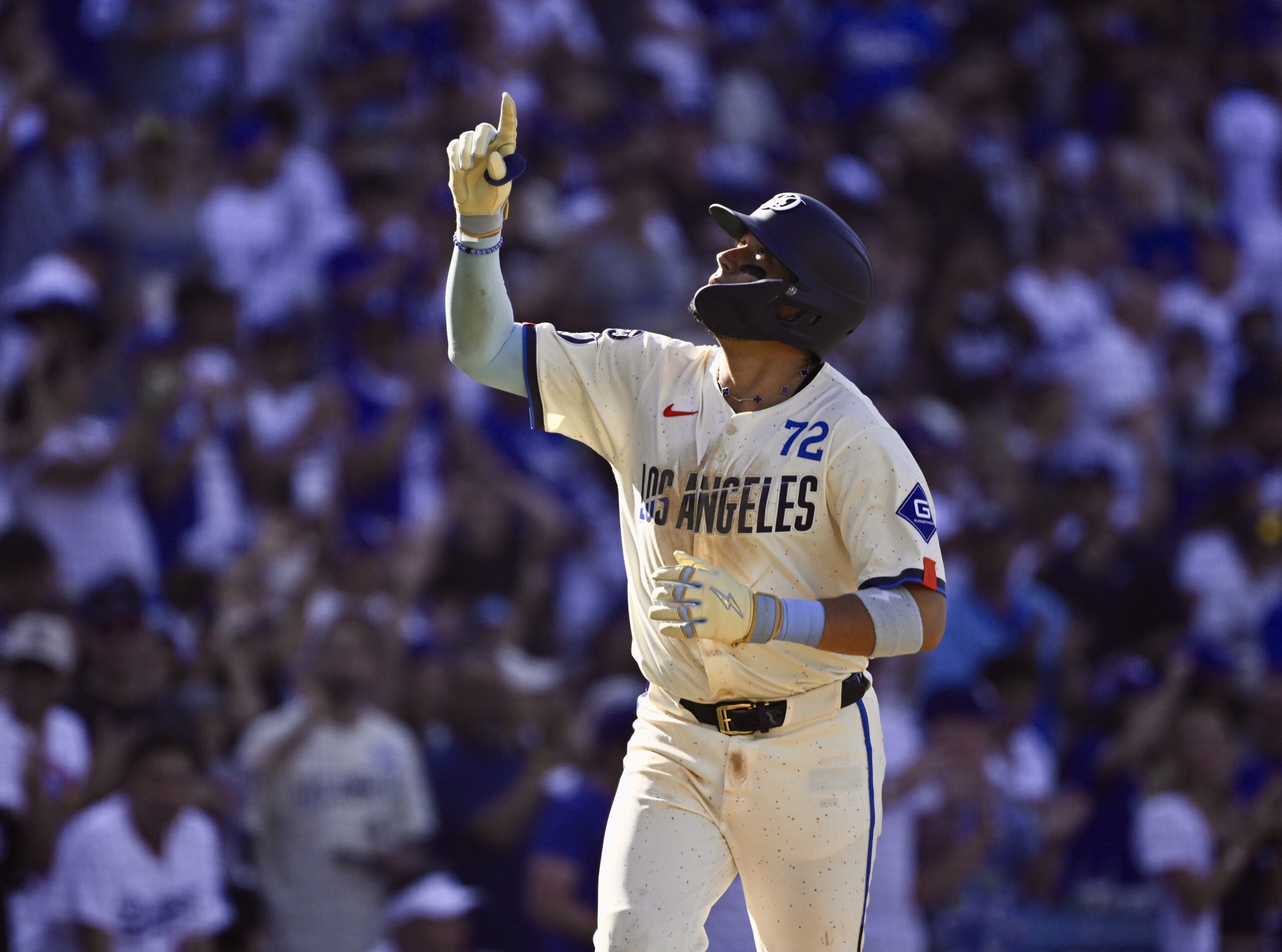 Miguel Rojas #72 of the Dodgers points to the sky...