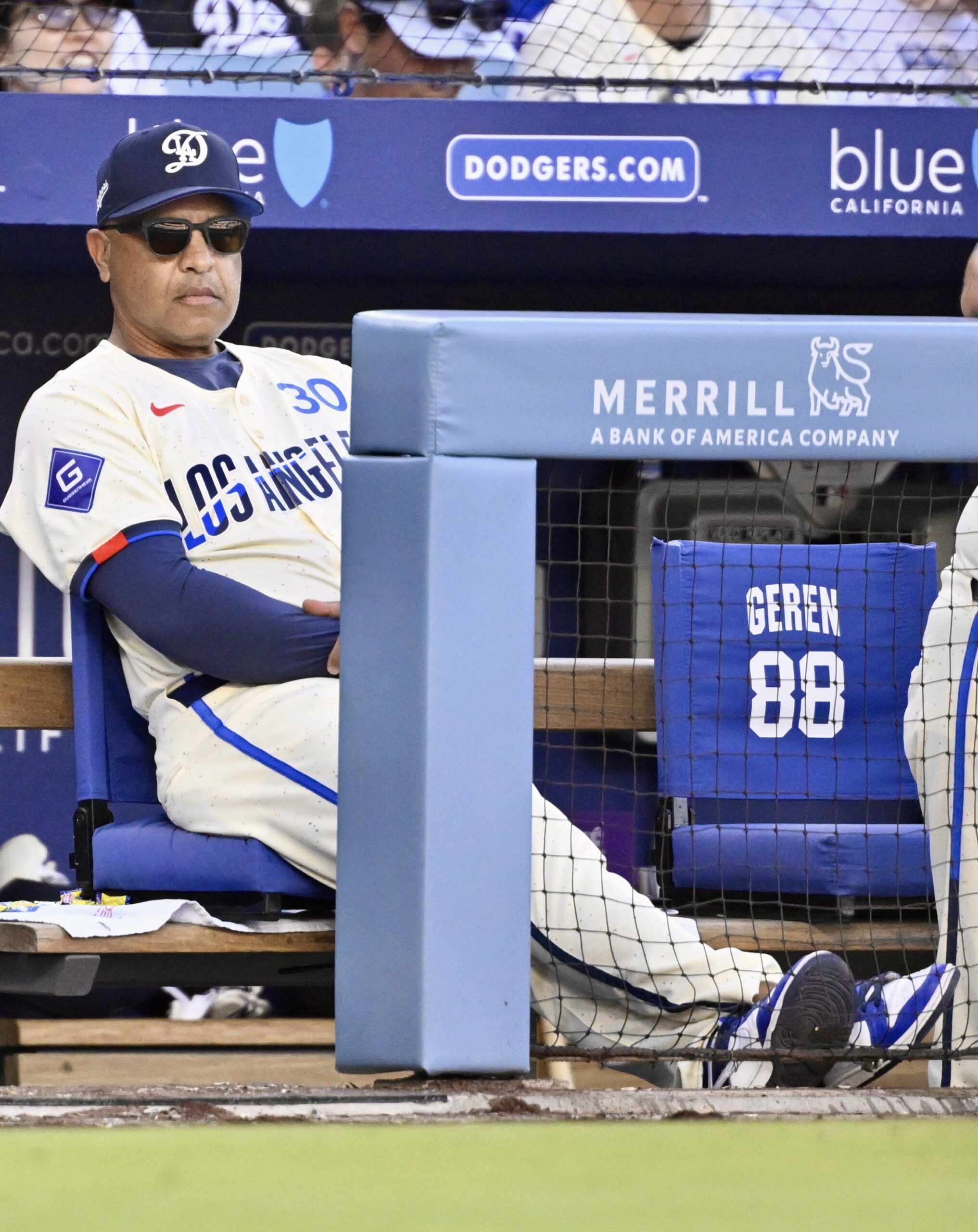 Manager Dave Roberts #30 of the Dodgers looks on against...