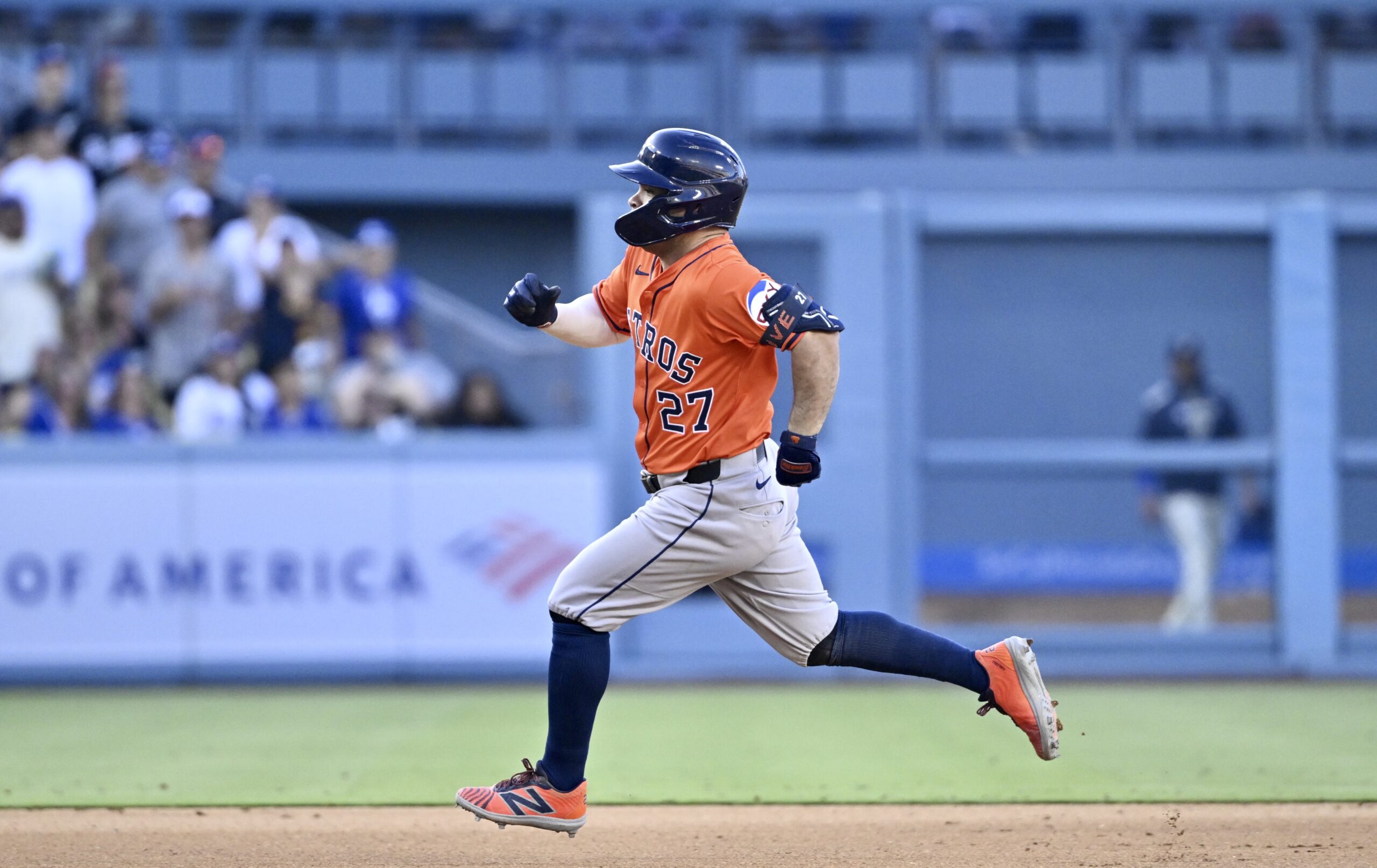Jose Altuve #27 of the Houston Astros triples against the...