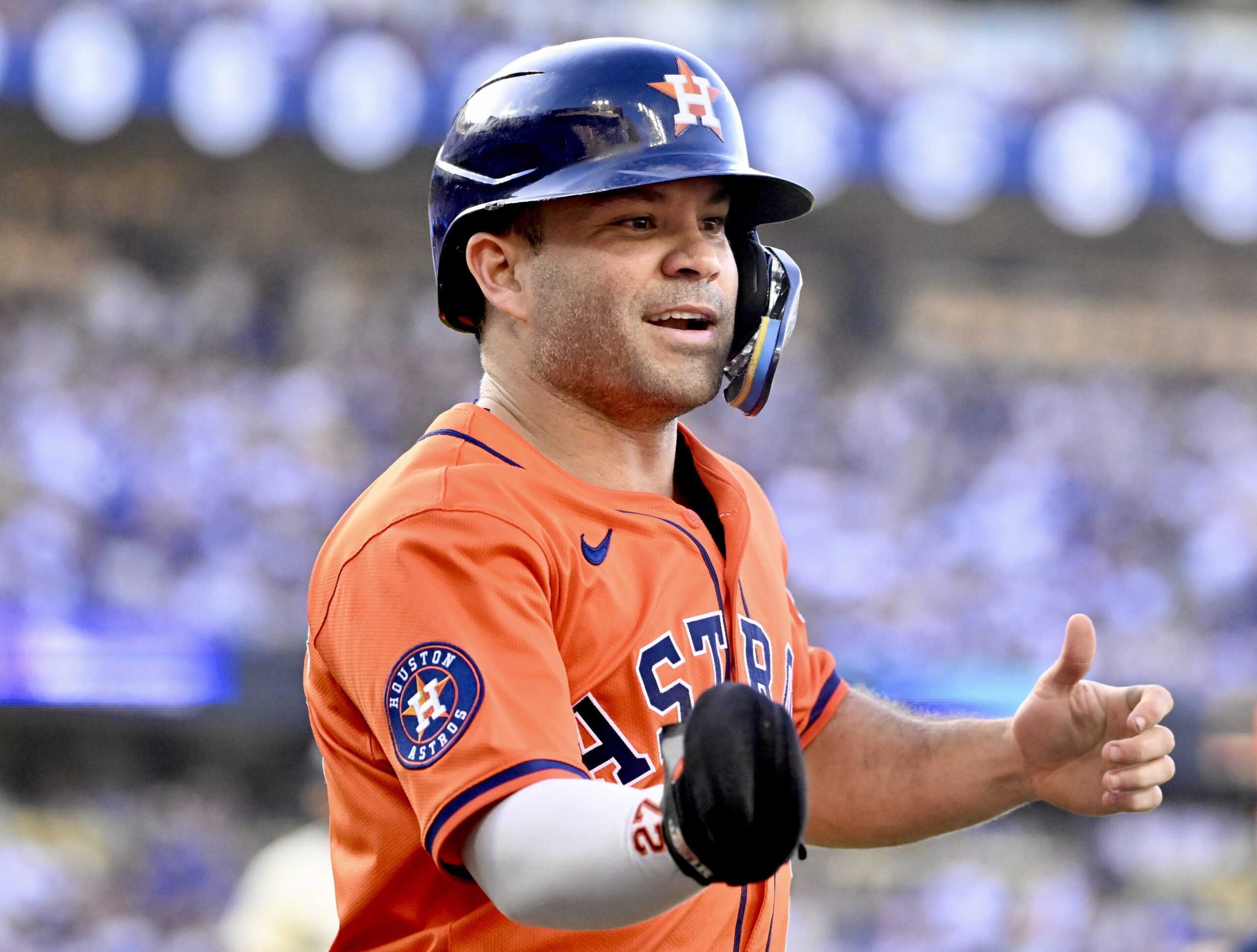 Jose Altuve #27 of the Houston Astros reacts after scoring...