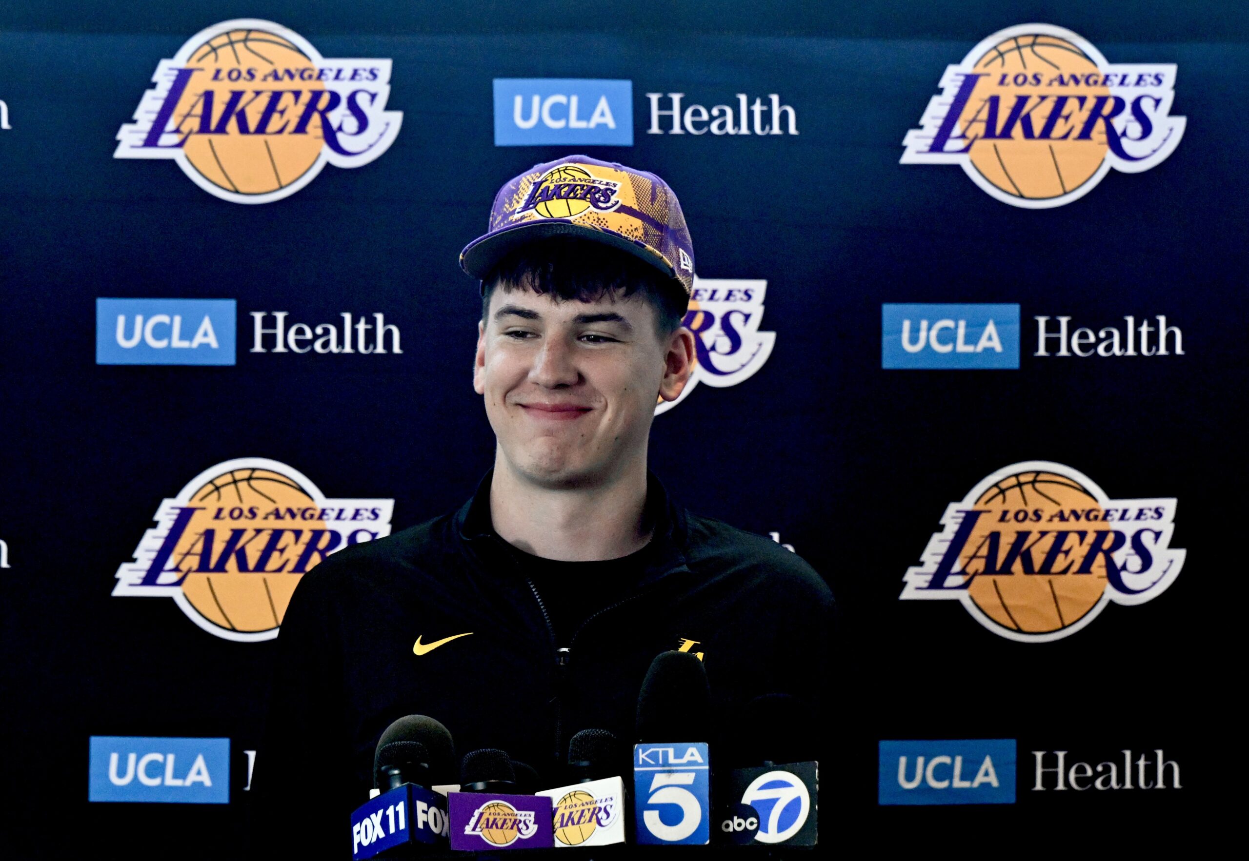 New Lakers forward Jake LaRavia smiles during an introductory press...