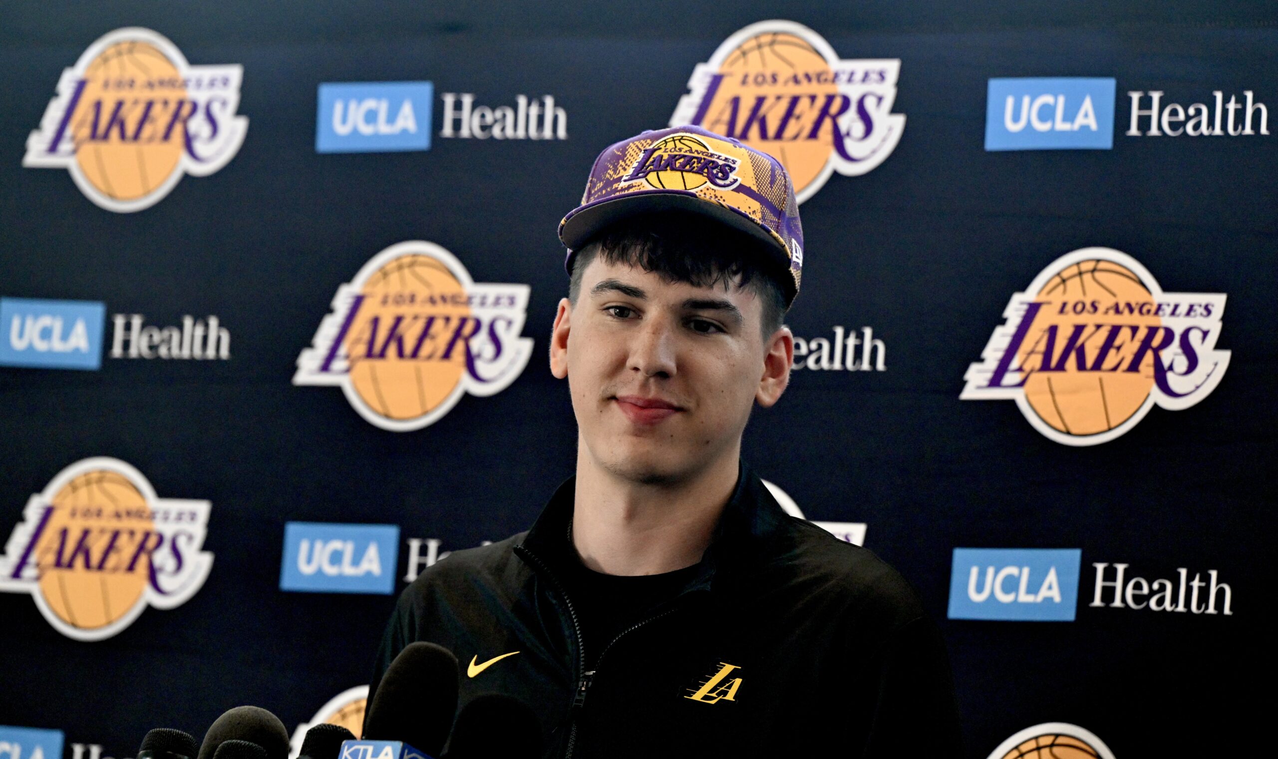 New Lakers forward Jake LaRavia listens to a question from...