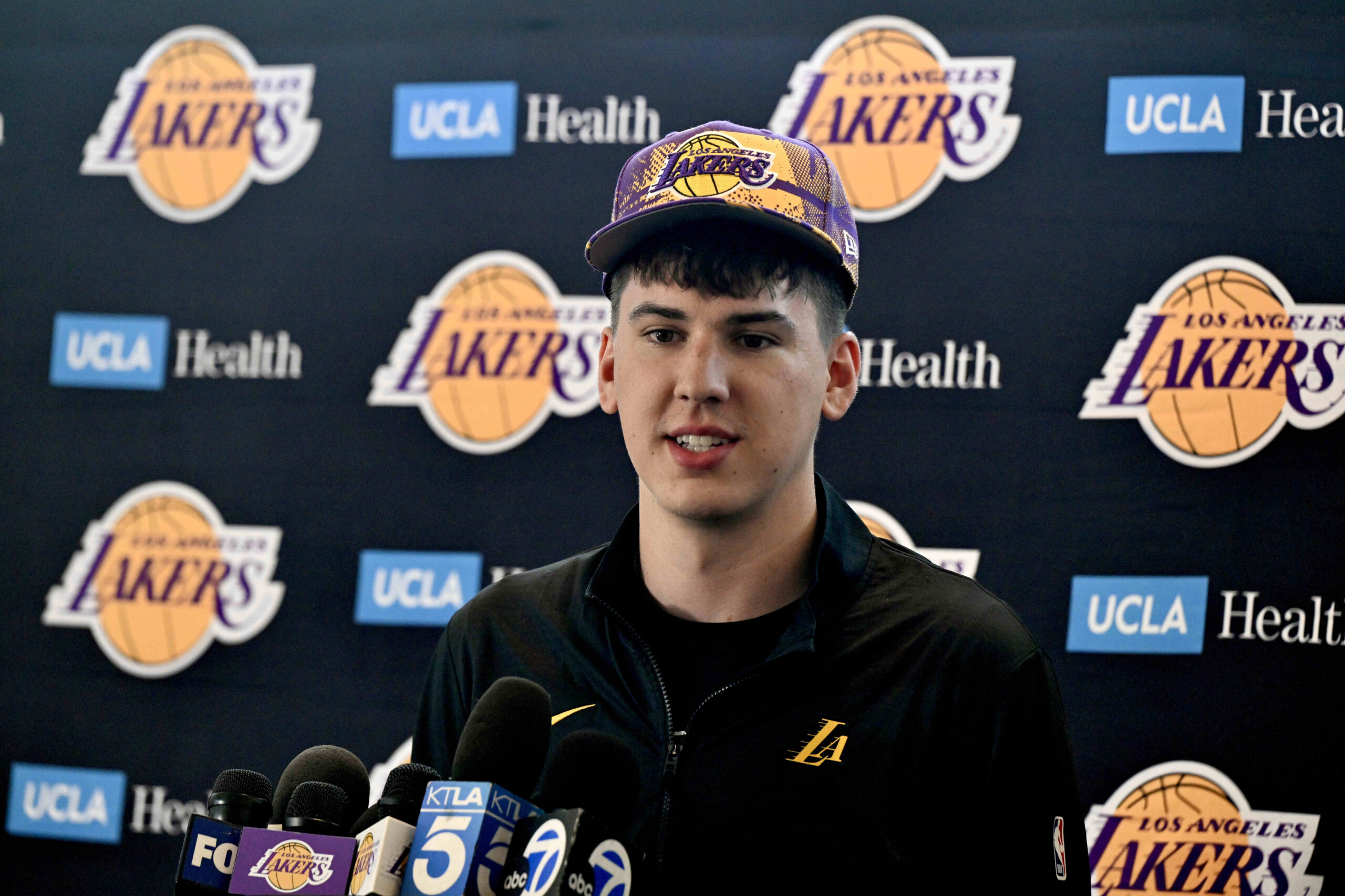 New Lakers forward Jake LaRavia speaks to reporters during an...