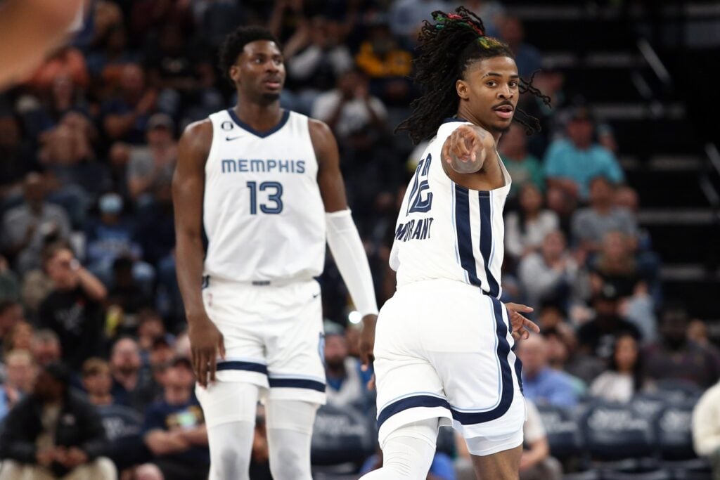 Memphis Grizzlies guard Ja Morant (12) points toward Memphis Grizzlies guard Desmond Bane (not pictured) after an assist during the second half against the Portland Trail Blazers at FedExForum.