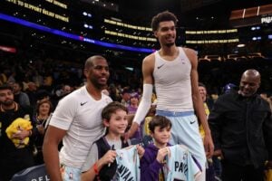 Jan 13, 2025; Los Angeles, California, USA; San Antonio Spurs guard Chris Paul (3, left) and center Victor Wembanyama (1,right) pose for a photo with Los Angeles Lakers head coach JJ Redick's sons after defeating the Lakers 126-102 at Crypto.com Arena. Mandatory Credit: Kiyoshi Mio-Imagn Images