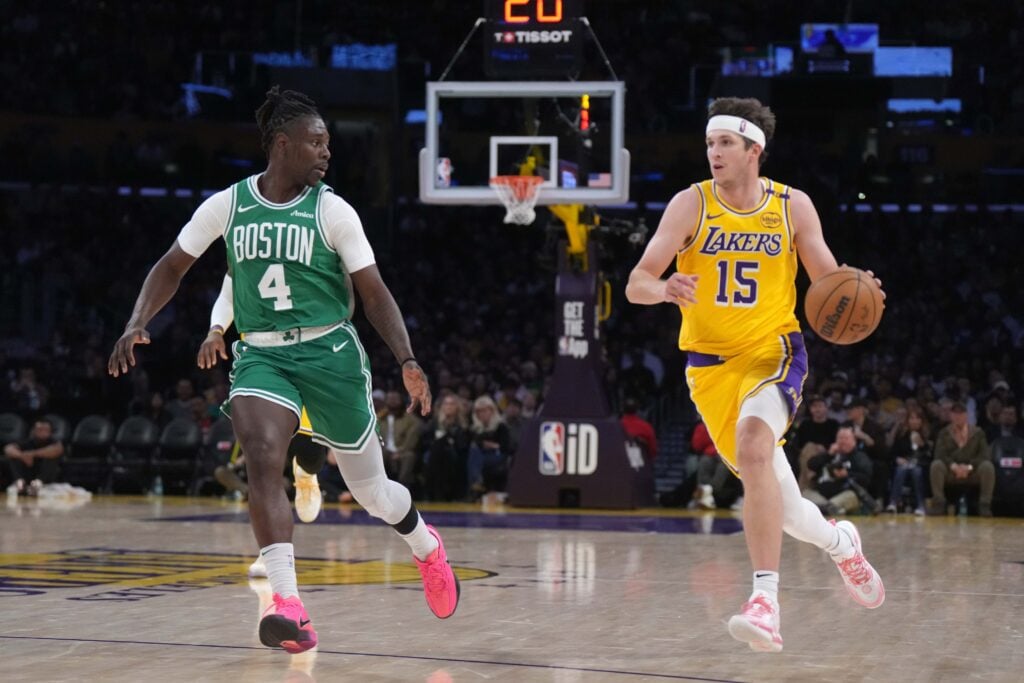 Jan 23, 2025; Los Angeles, California, USA; Los Angeles Lakers guard Austin Reaves (15) dribbles the ball against Boston Celtics guard Jrue Holiday (4) in the second half at the Crypto.com Arena. Mandatory Credit: Kirby Lee-Imagn Images