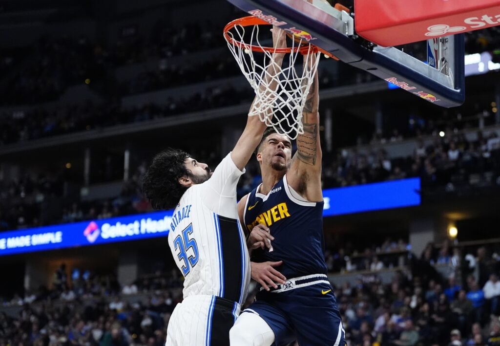 Feb 6, 2025; Denver, Colorado, USA; Orlando Magic center Goga Bitadze (35) blocks a shot by Denver Nuggets forward Michael Porter Jr. (1) in the second quarter at Ball Arena. Mandatory Credit: Ron Chenoy-Imagn Images