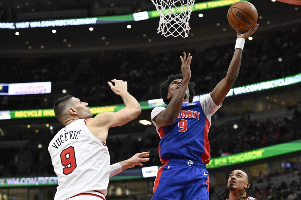 Feb 12, 2025; Chicago, Illinois, USA; Detroit Pistons forward Ausar Thompson (9) shoots against Chicago Bulls center Nikola Vucevic (9) during the second half at the United Center. Mandatory Credit: Matt Marton-Imagn Images