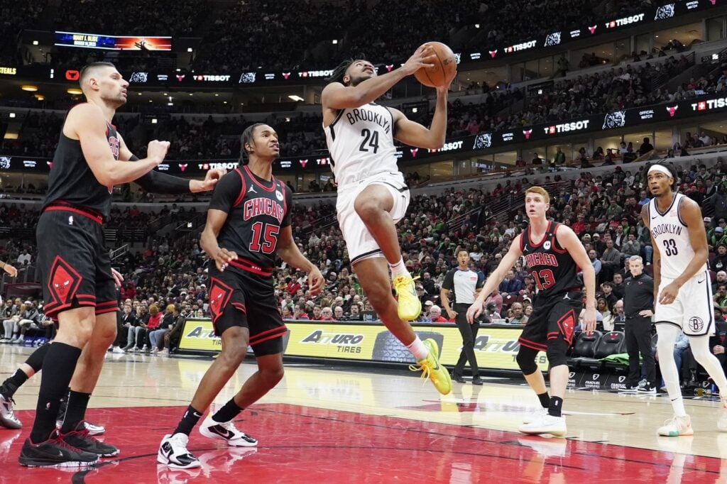Mar 13, 2025; Chicago, Illinois, USA; Chicago Bulls forward Julian Phillips (15) defends Brooklyn Nets guard Cam Thomas (24) during the second half at United Center. Mandatory Credit: David Banks-Imagn Images