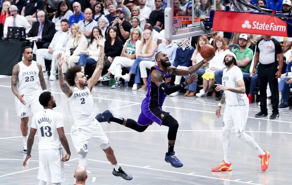 Apr 9, 2025; Dallas, Texas, USA; Los Angeles Lakers forward LeBron James (23) shoots past Dallas Mavericks center Dereck Lively II (2) and Dallas Mavericks forward Anthony Davis (3) during the second half at American Airlines Center. Mandatory Credit: Kevin Jairaj-Imagn Images