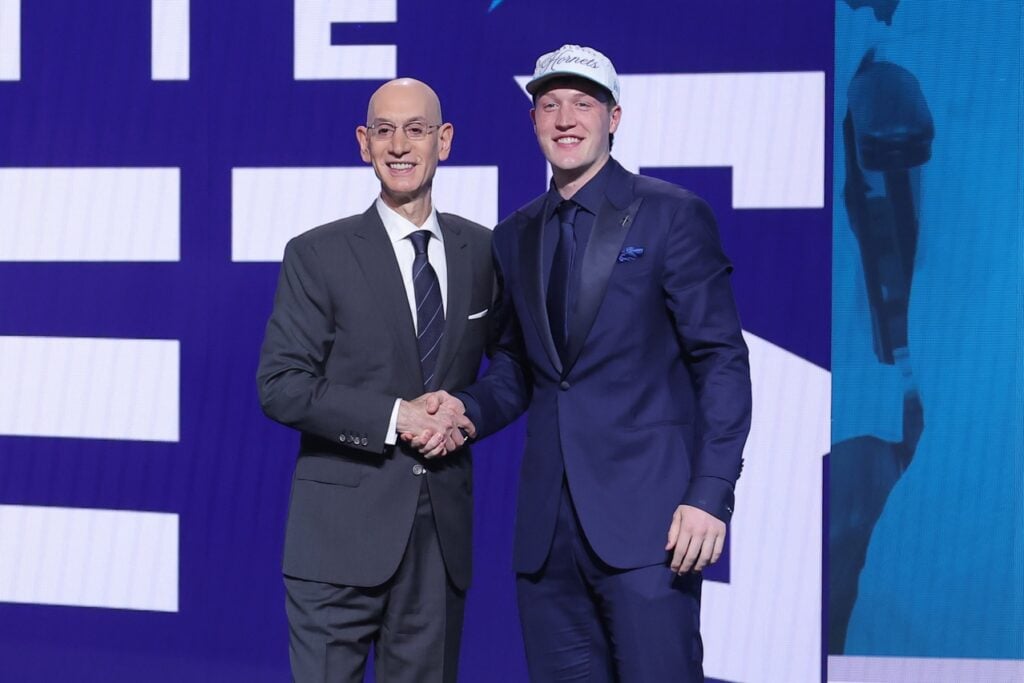 Kon Knueppel stands with NBA commissioner Adam Silver after being selected as the fourth pick by the Charlotte Hornets in the first round of the 2025 NBA Draft at Barclays Center.