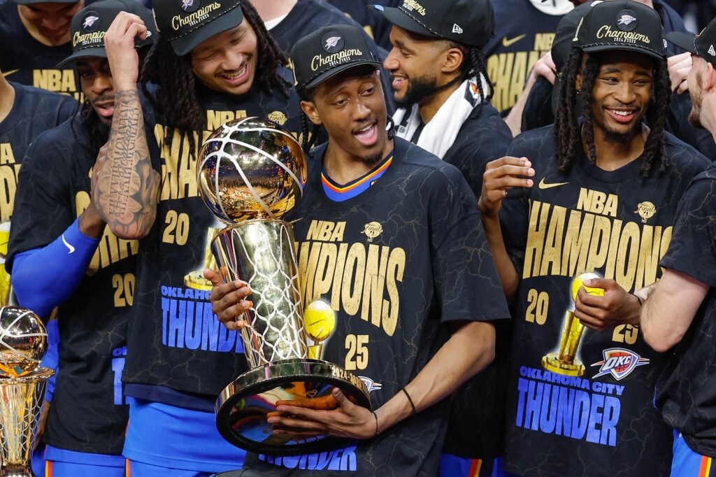 Oklahoma City Thunder forward Jalen Williams (8) holds the NBA Larry O'Brien Championship Trophy at the end of game seven of the 2025 NBA Finals after defeating the Indiana Pacers at Paycom Center.