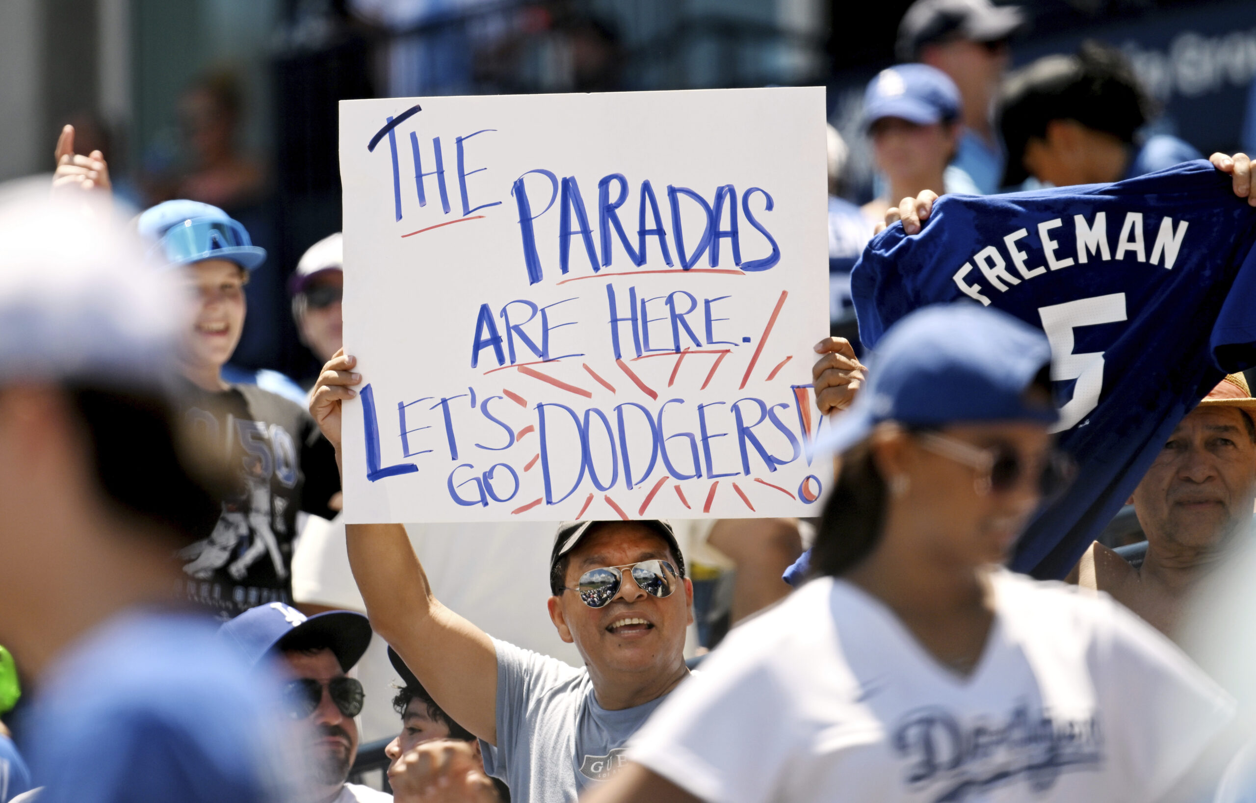 Dodgers’ fans cheer on their team during the seventh inning...