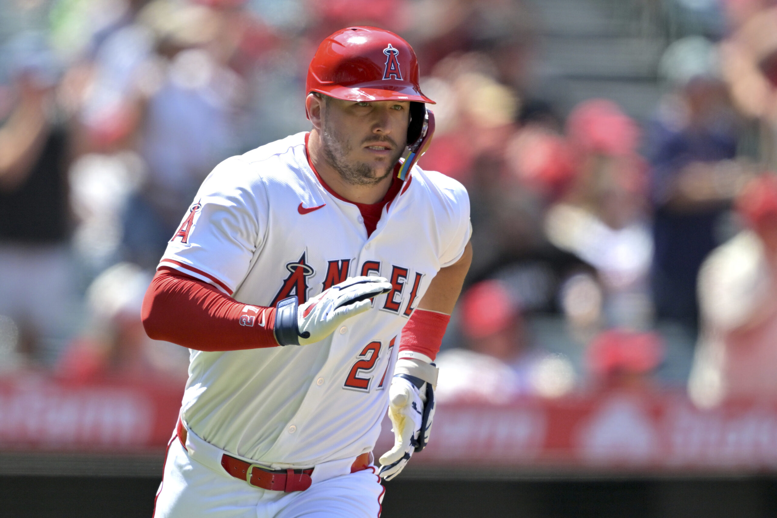 Angels’ Mike Trout runs to first on a single during...