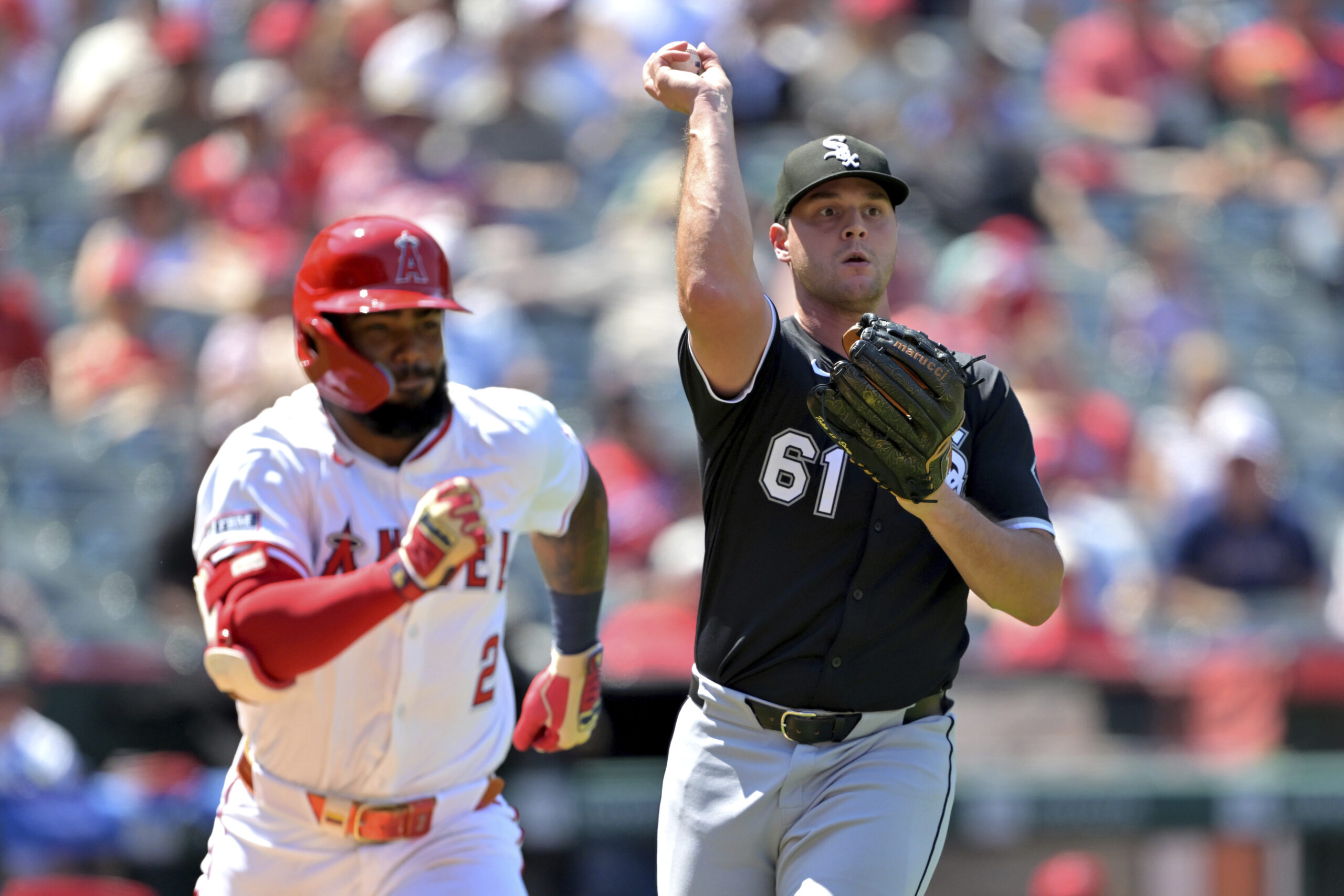 Angels’ Luis Rengifo, left, is thrown out at first base...