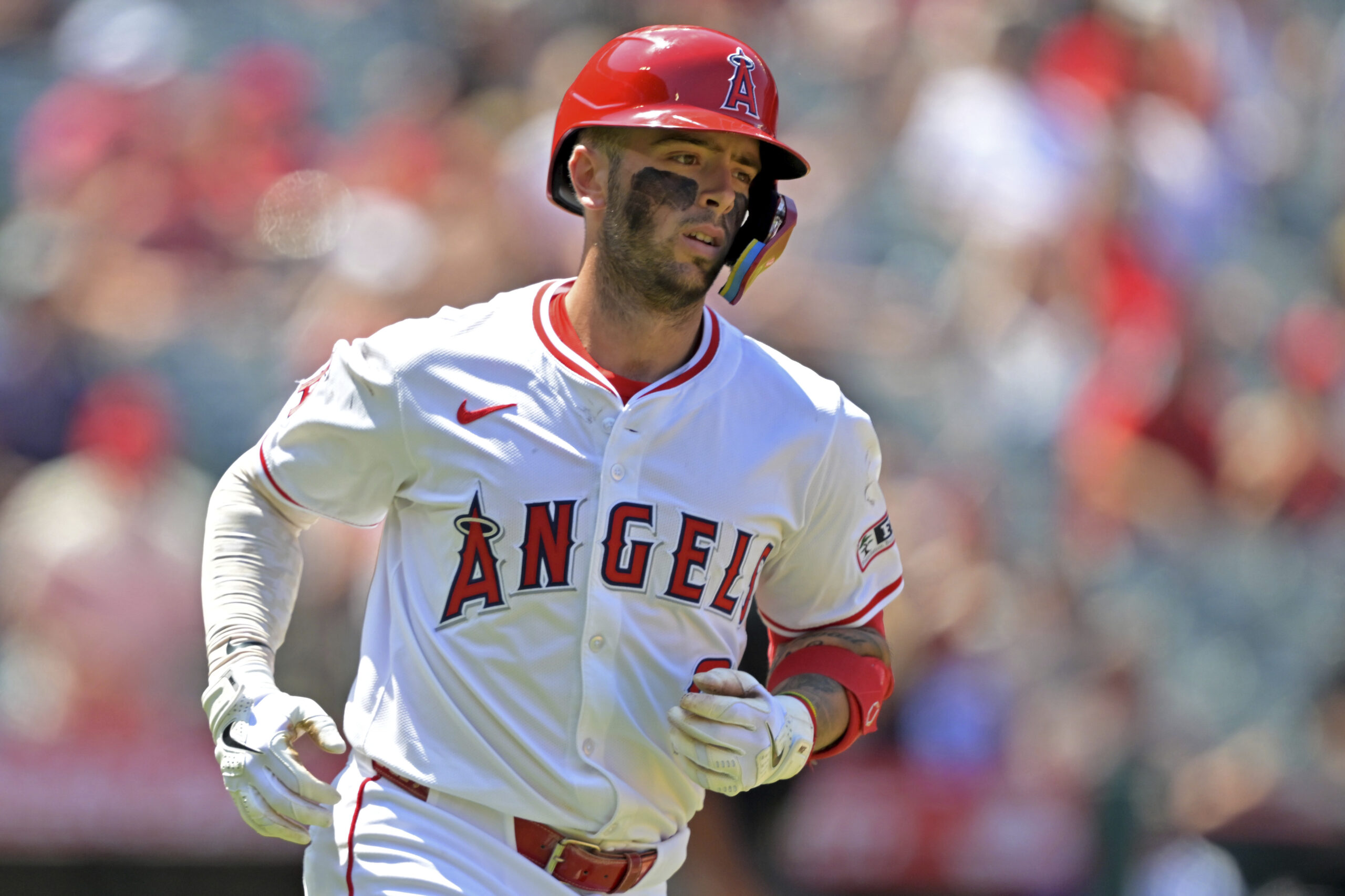 Angels’ Zach Neto rounds the bases after hitting a solo...