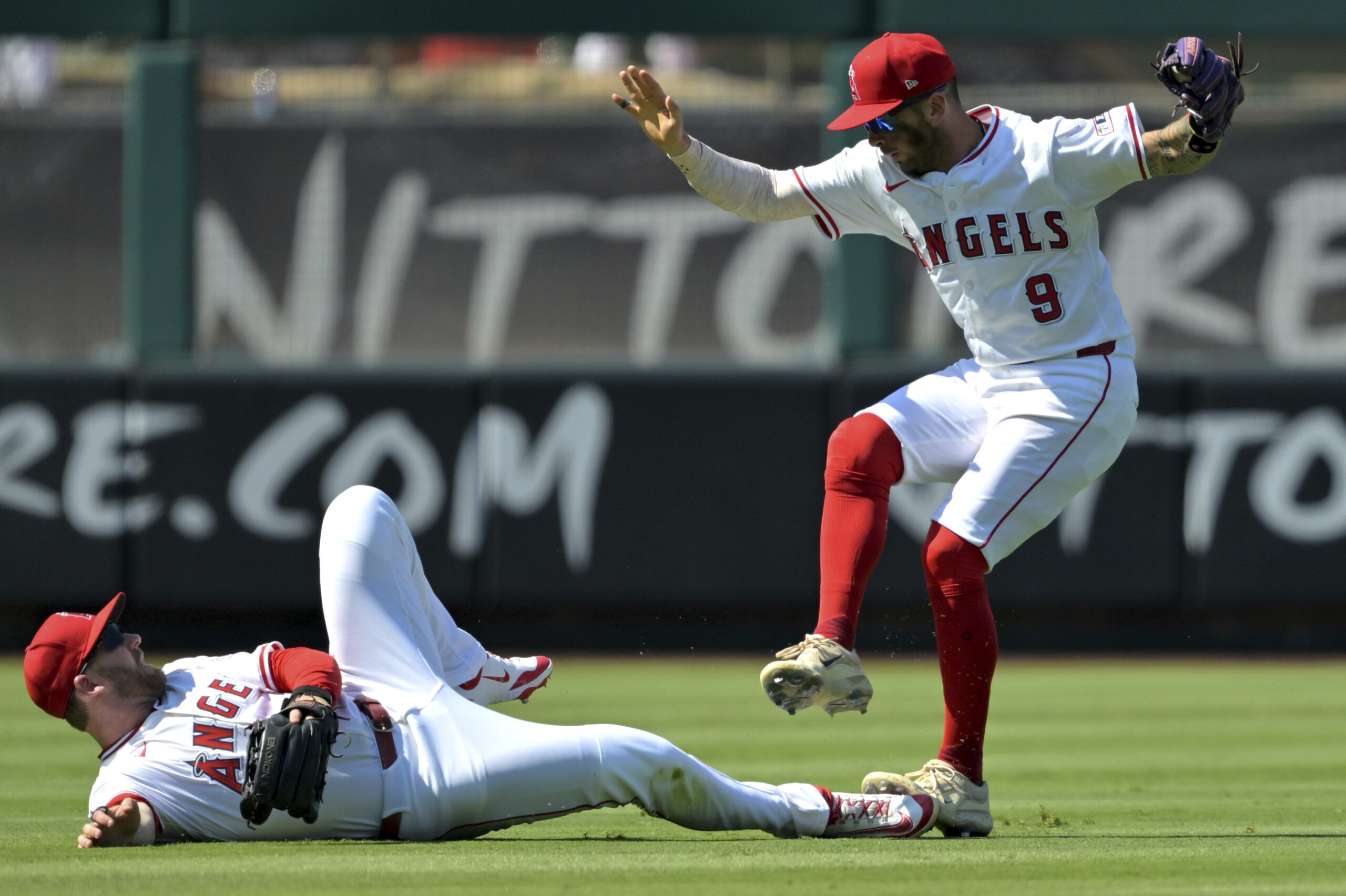 Angels shortstop Zach Neto (9) steps on the foot of...