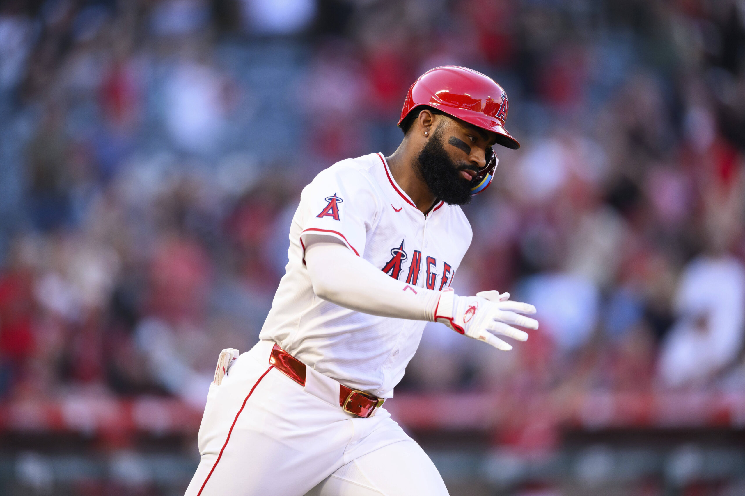 The Angels’ Jo Adell runs after hitting a home run...