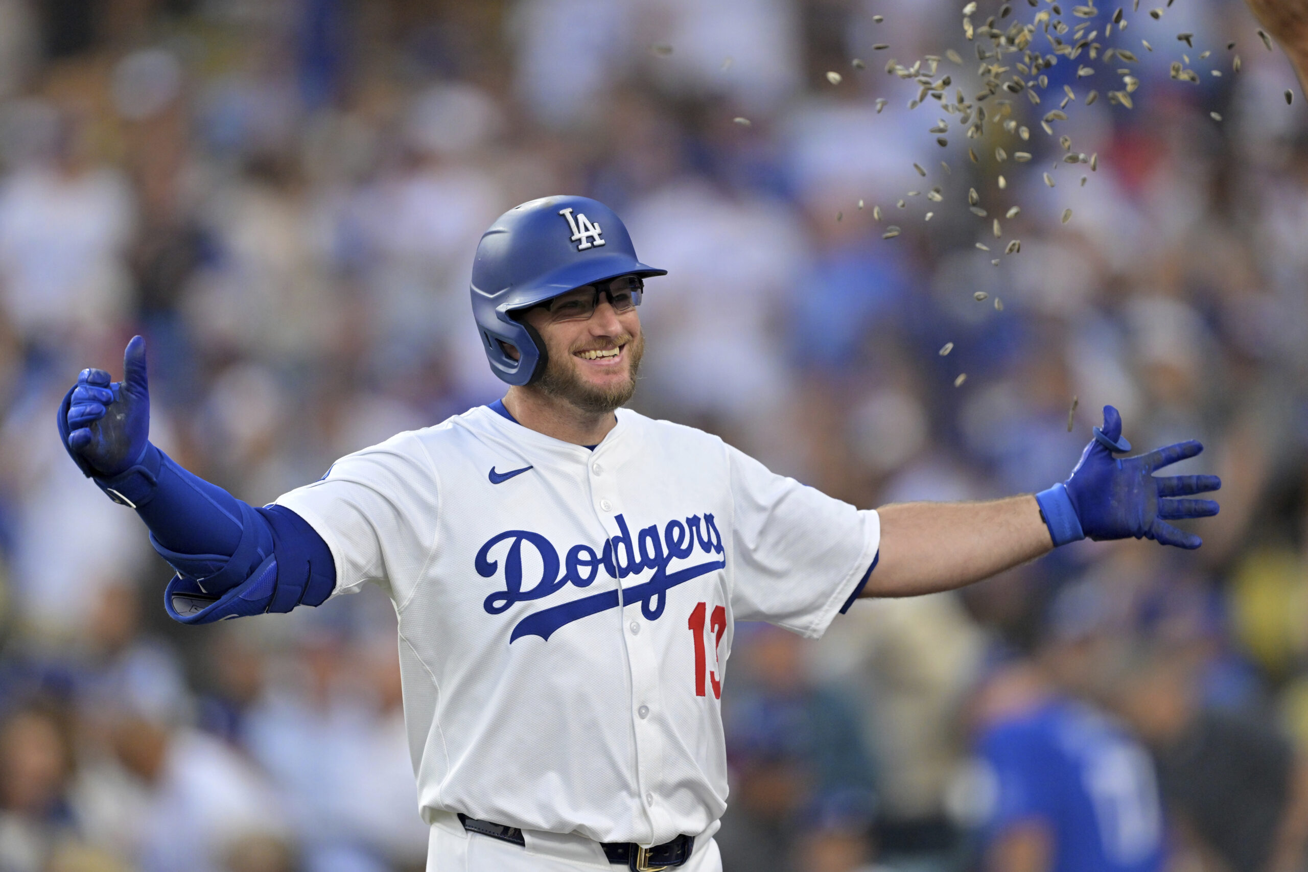 Los Angeles Dodgers’ Max Muncy gets showered with seeds at...