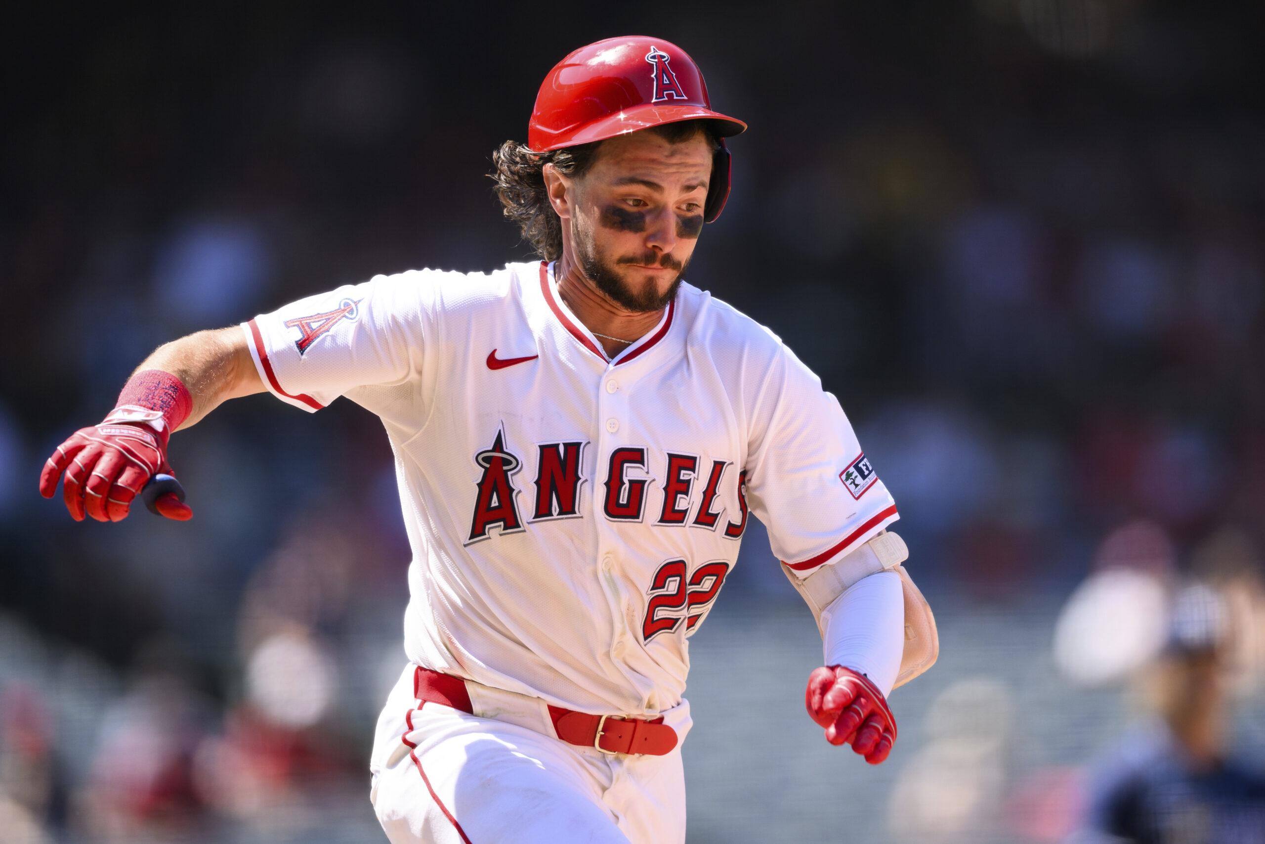 Angels’ Bryce Teodosio runs after hitting a single during the...
