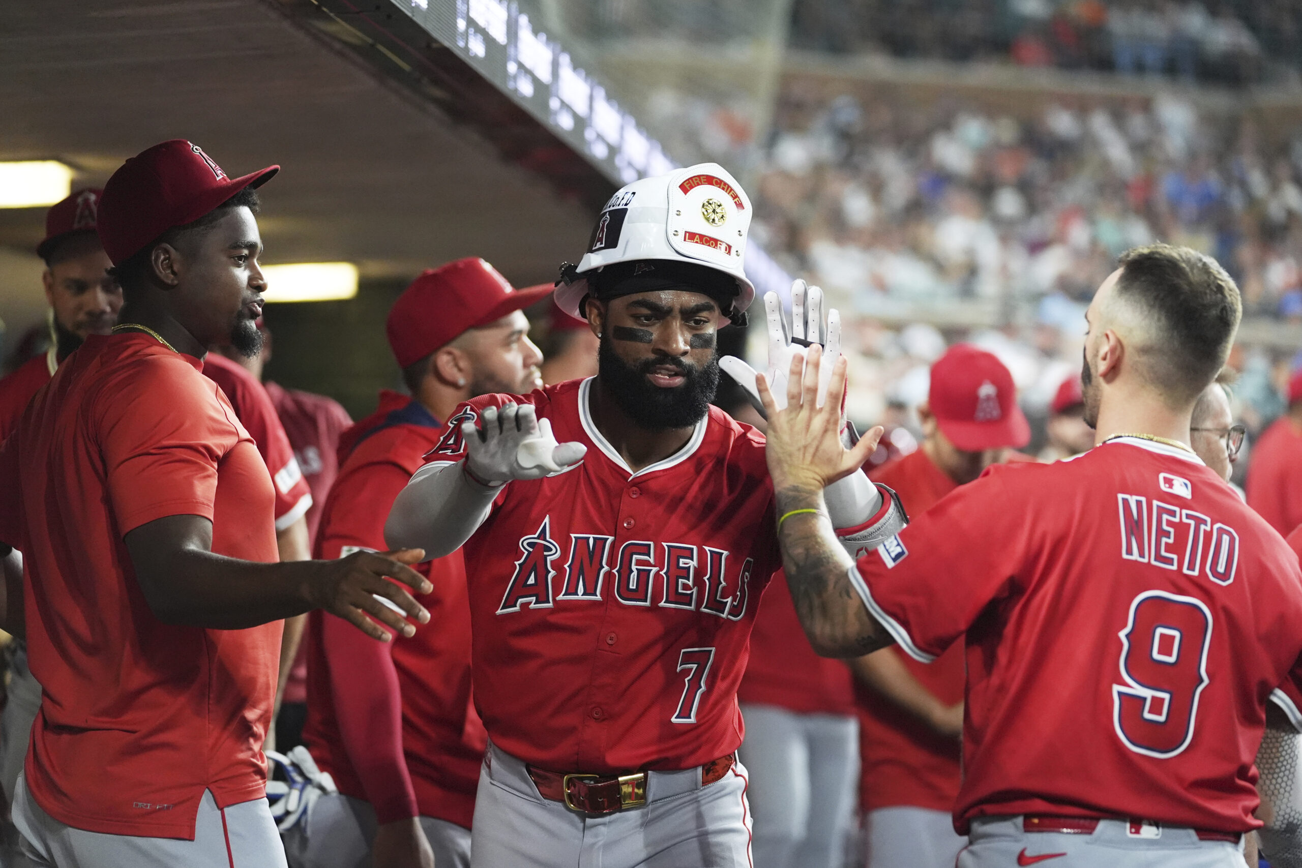 Angels’ Jo Adell, center, celebrates after hitting a solo home...