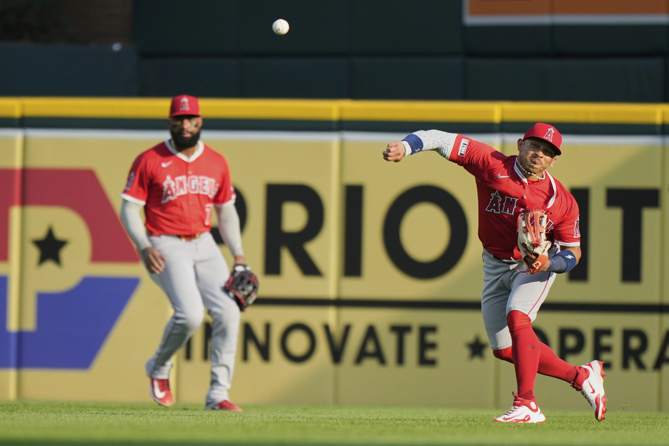 Angels right fielder Gustavo Campero, right, attempts to throw out...