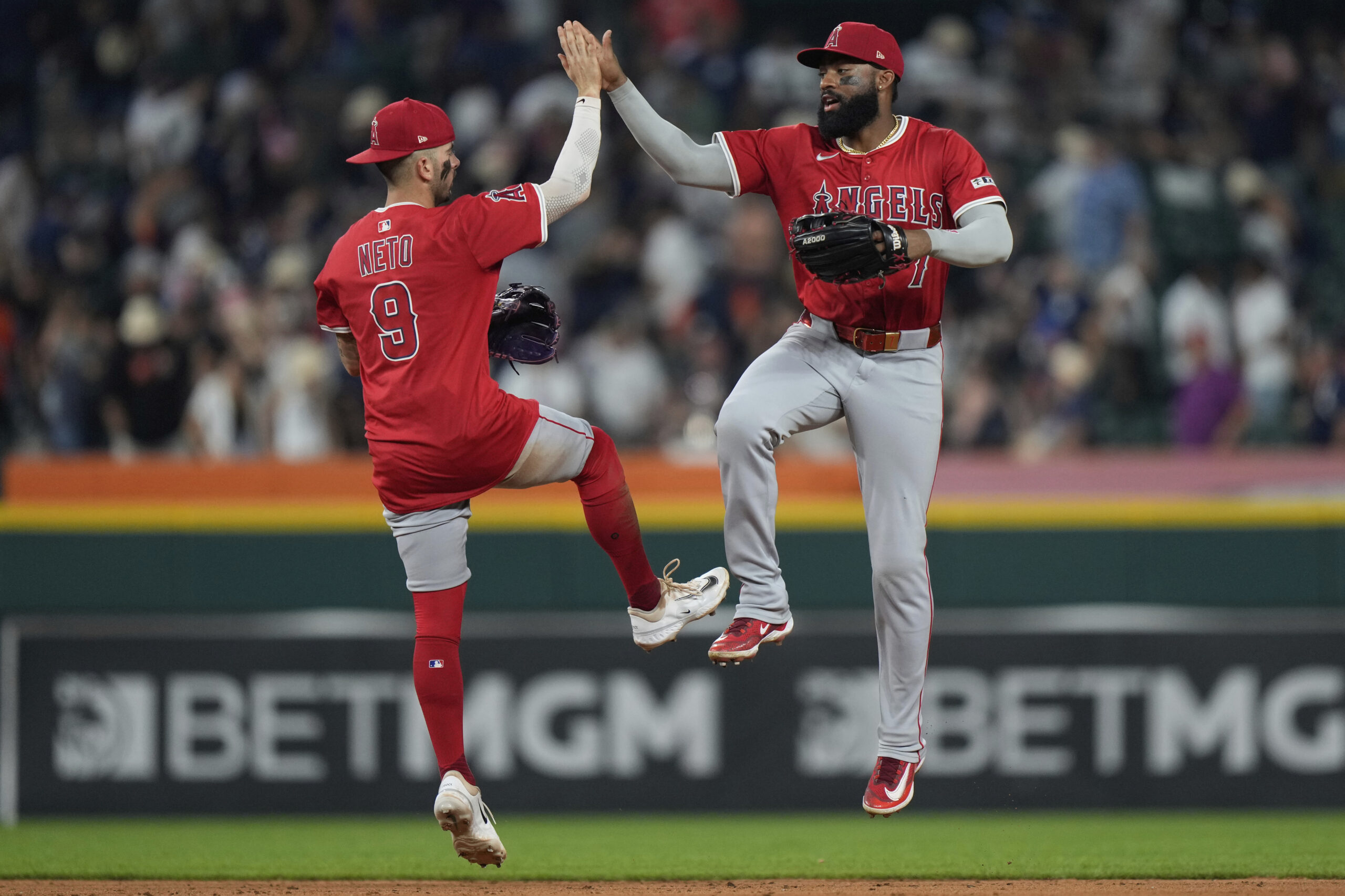 Angels center fielder Jo Adell, right, and shortstop Zach Neto...