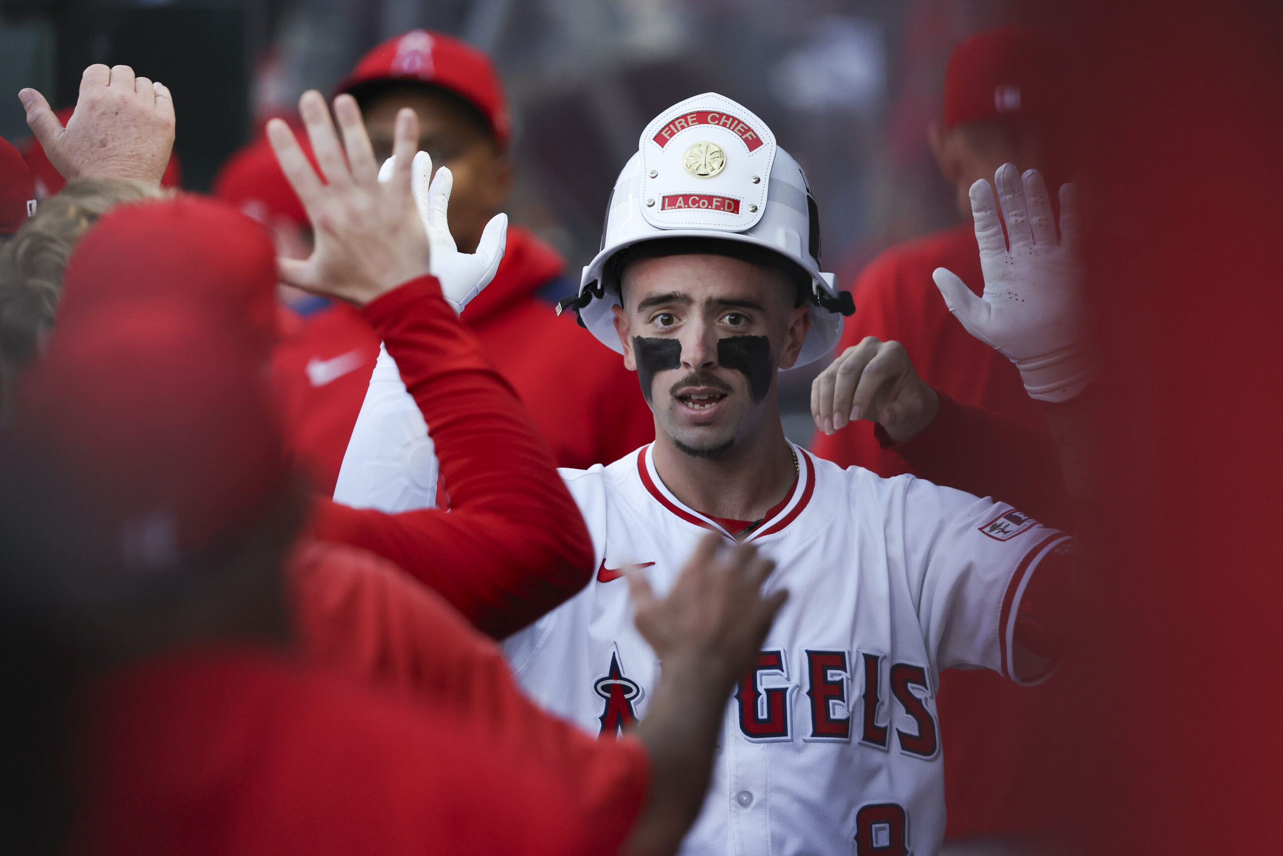 The Angels’ Zach Neto celebrates in the dugout after hitting...