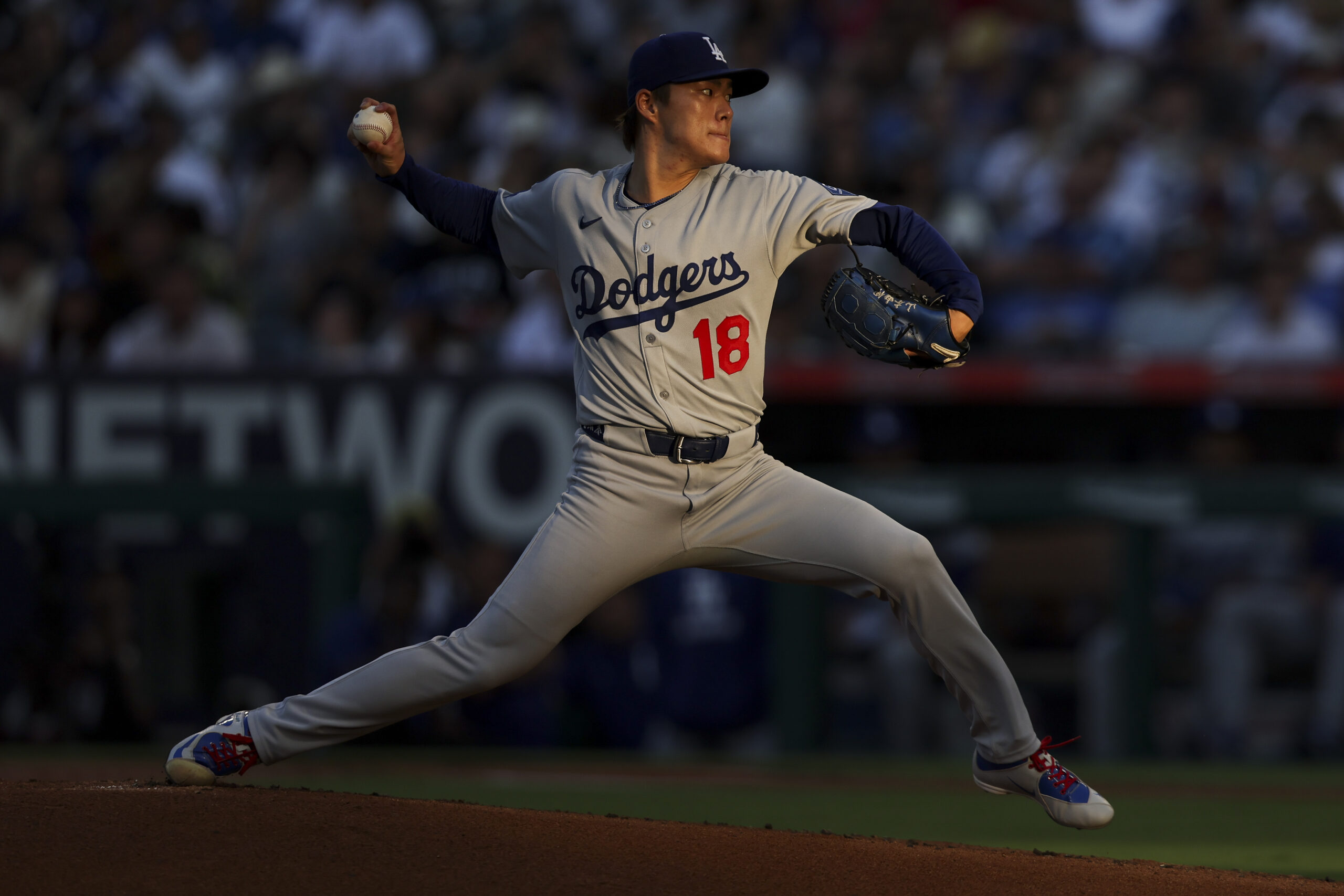 Dodgers starting pitcher Yoshinobu Yamamoto throws to the plate during...