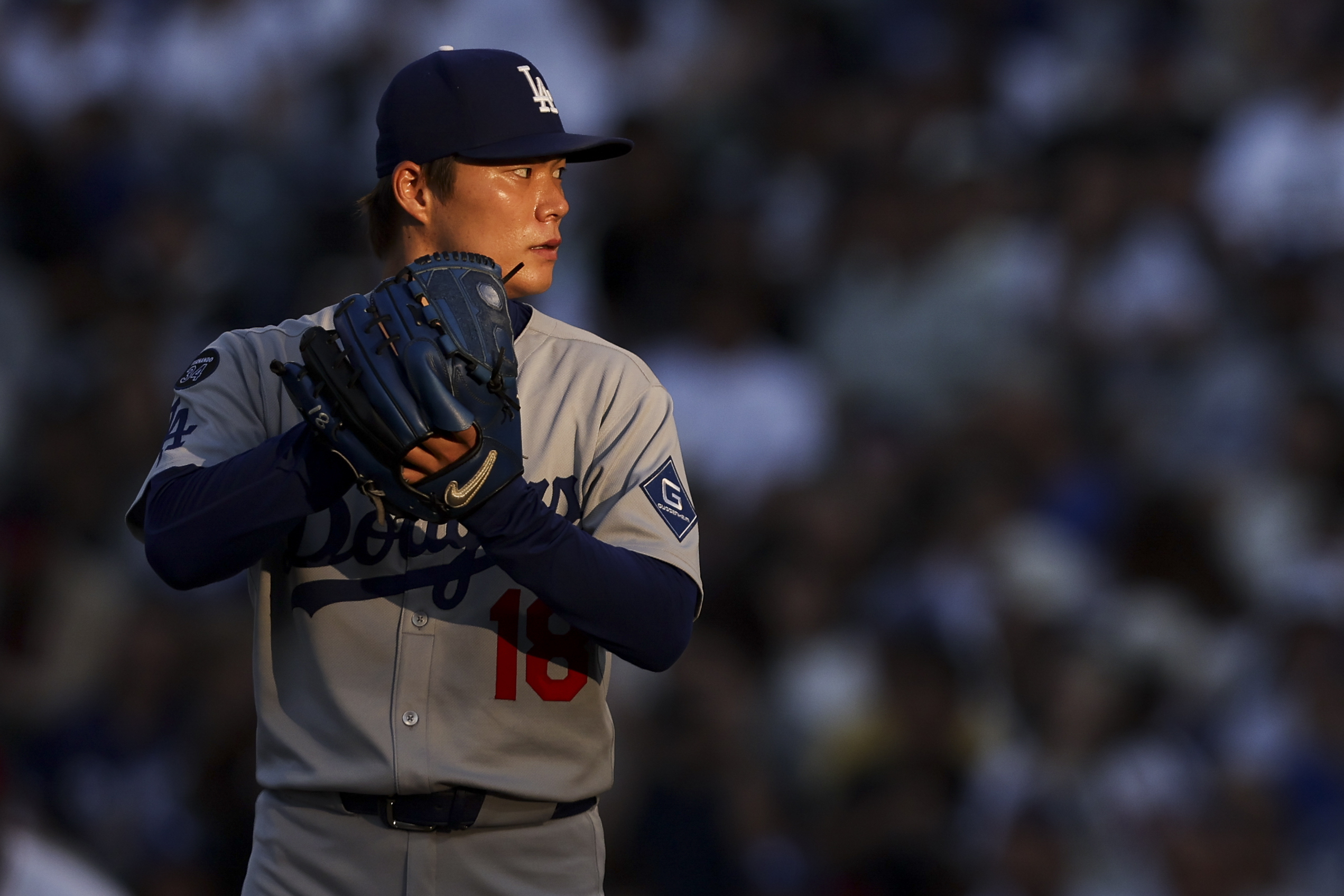 Dodgers starting pitcher Yoshinobu Yamamoto prepares to throw to the...