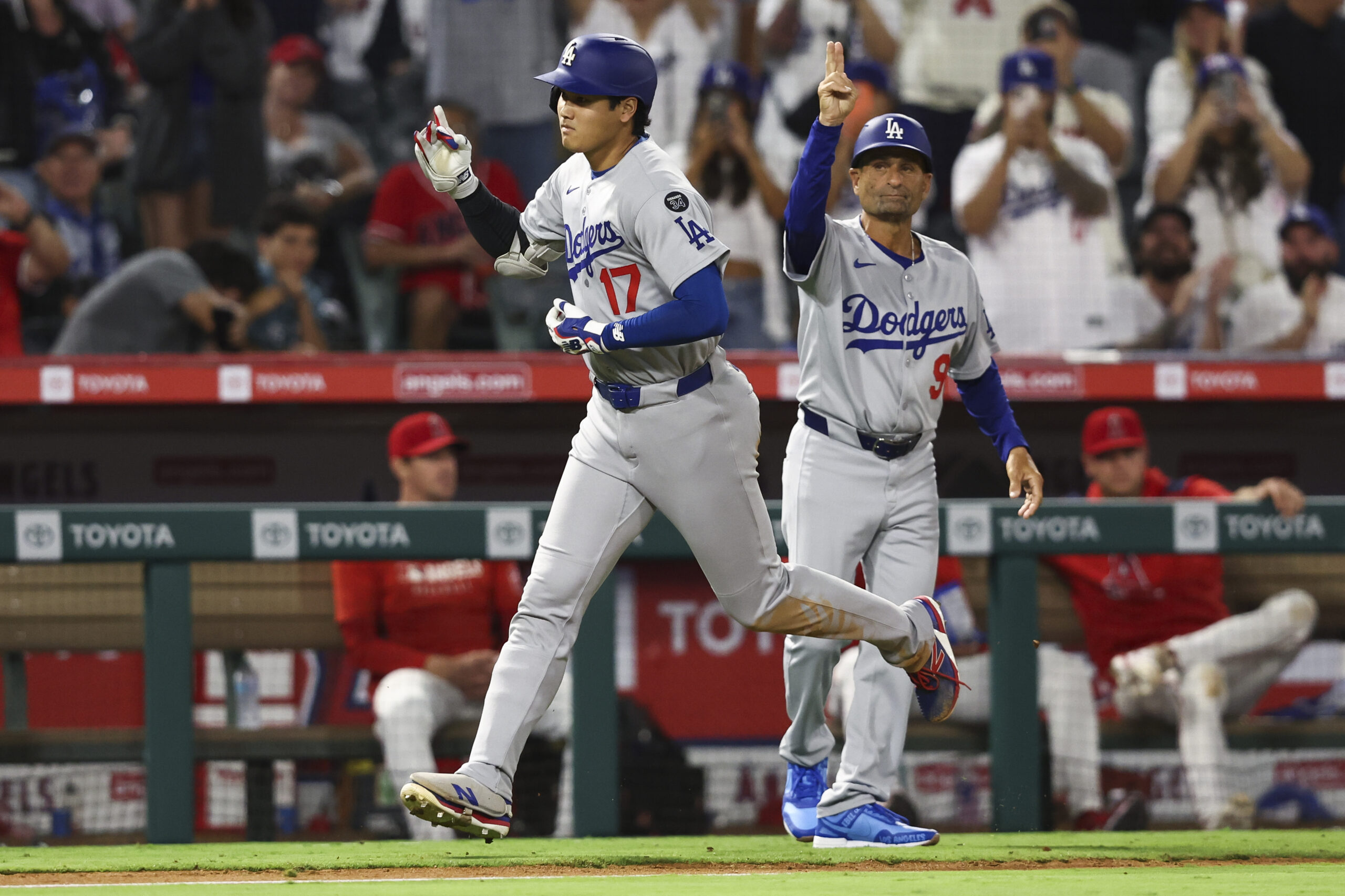 Fans cheer as Dodgers star Shohei Ohtani, left, celebrates with...
