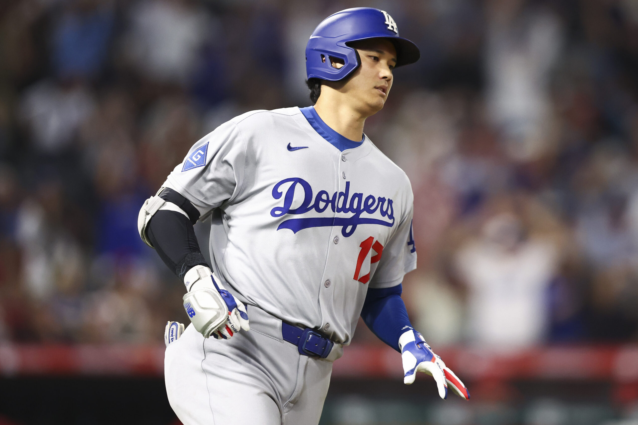 Dodgers star Shohei Ohtani gestures while running the bases after...
