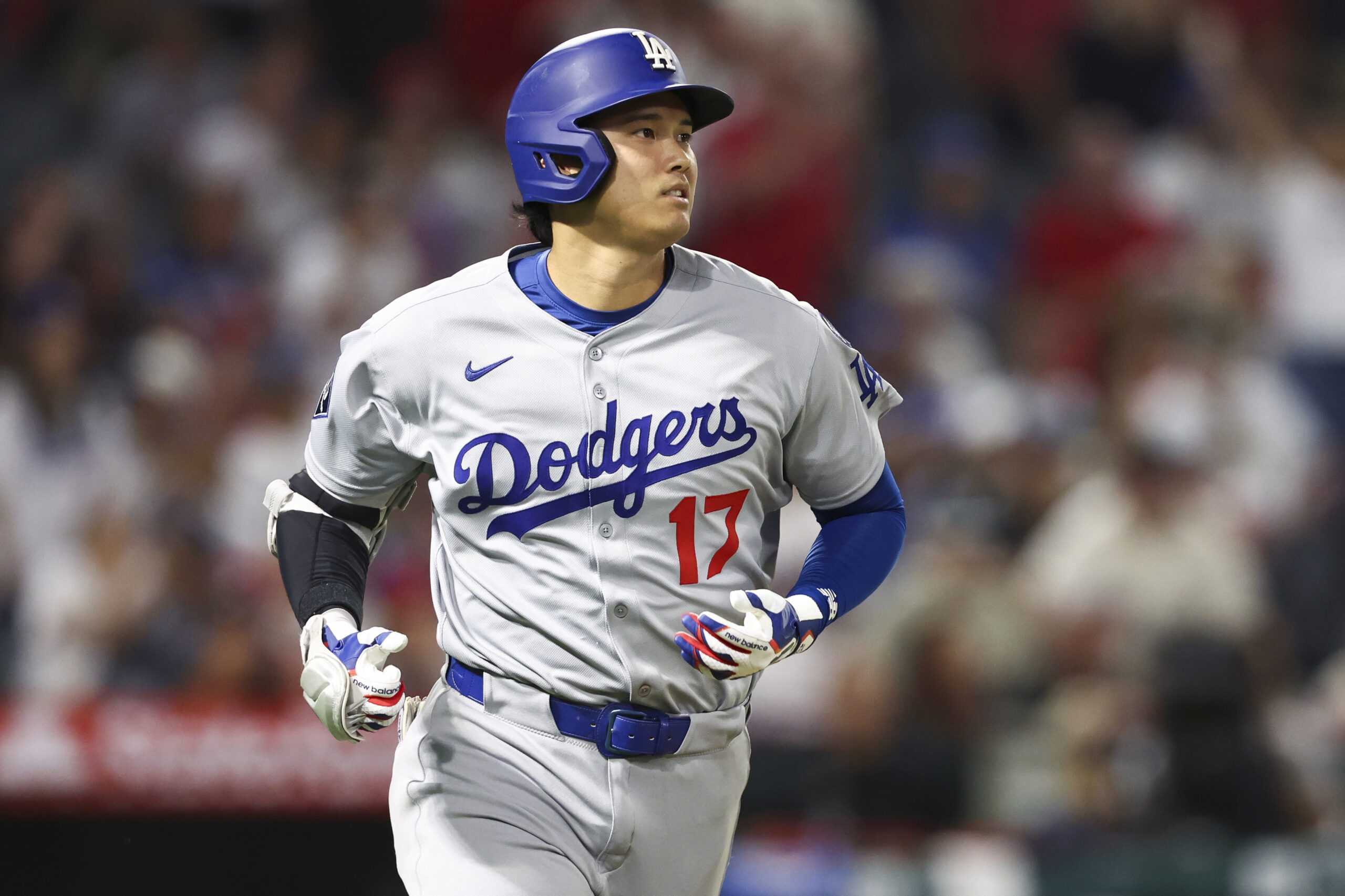 Dodgers star Shohei Ohtani begins to run the bases after...