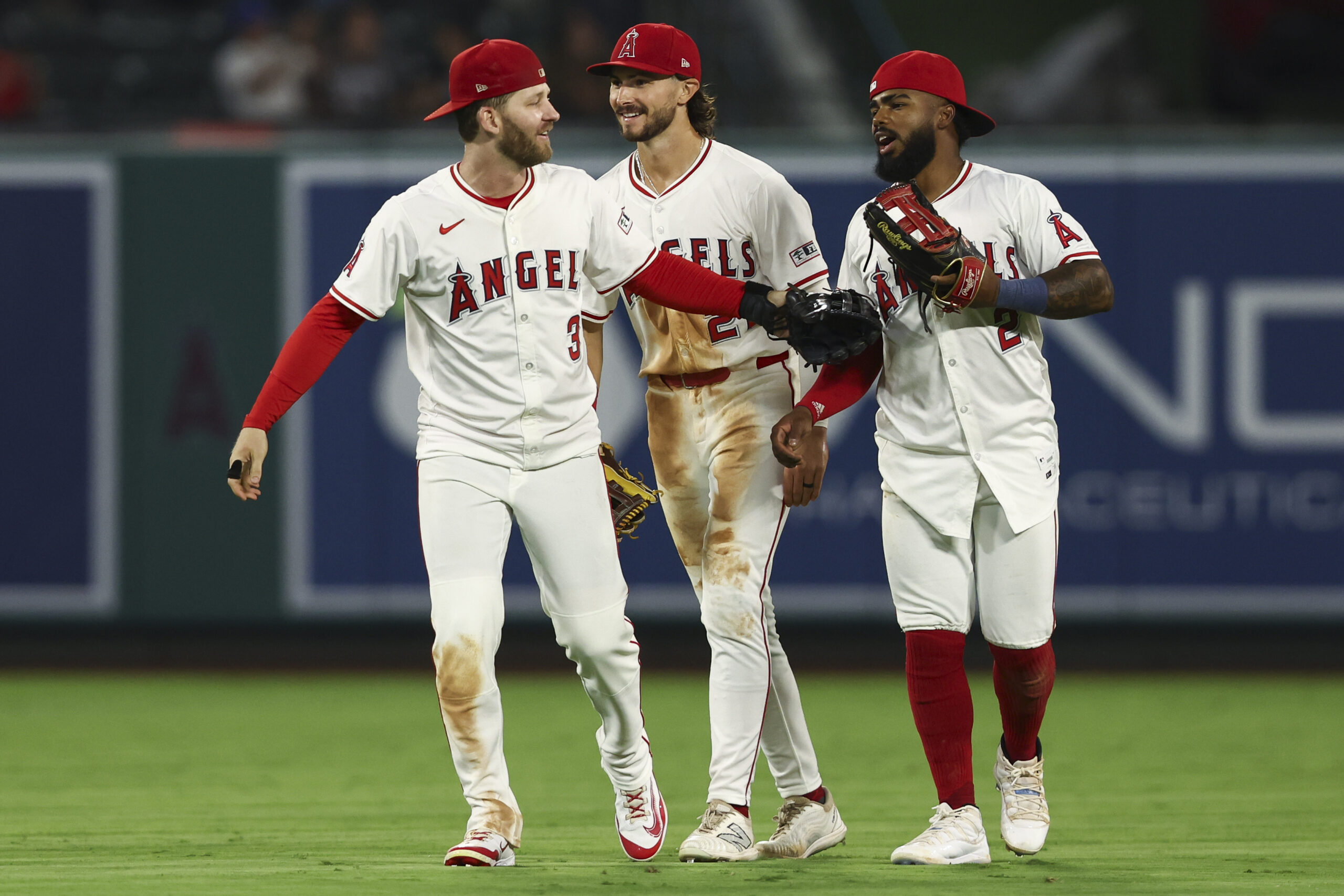 Angels outfielders Taylor Ward, left, Bryce Teodosio, center, and Luis...