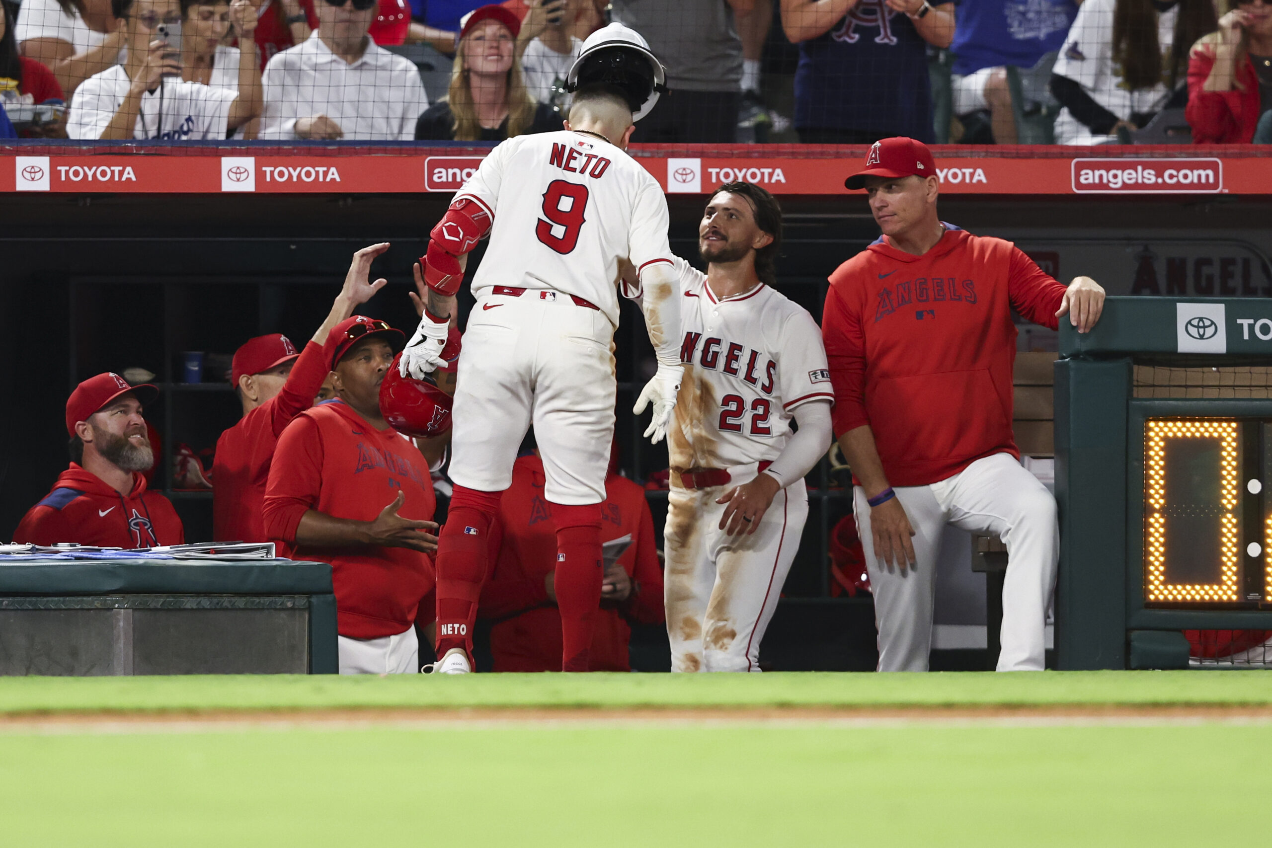 The Angels’ Bryce Teodosio (22) places a fire fighter’s helmet...