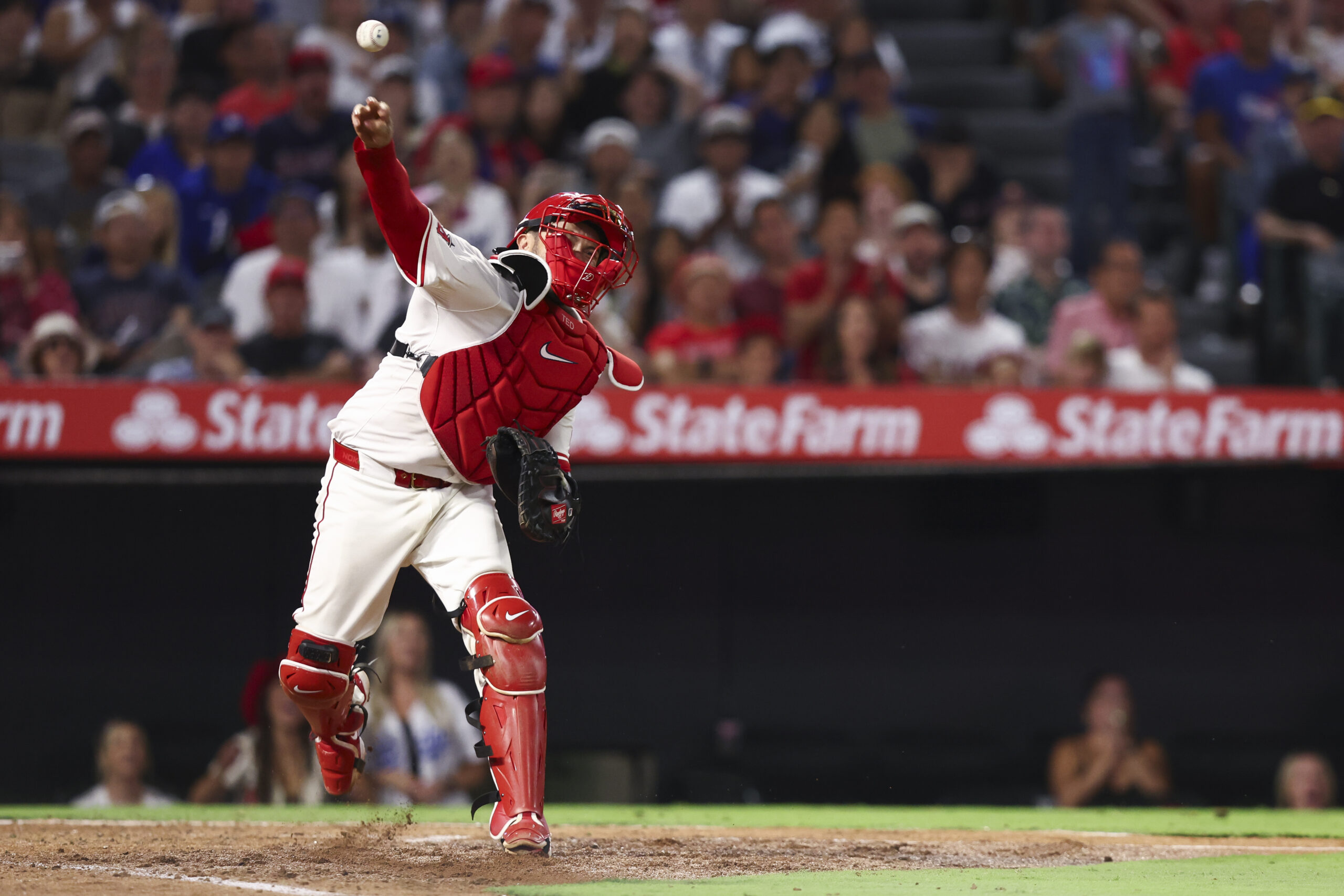 Angels catcher Travis d’Arnaud throws to first base to complete...