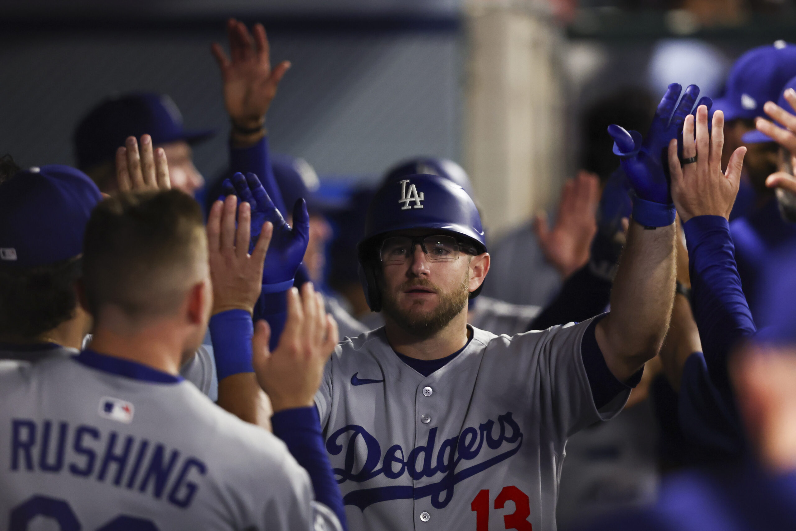 The Dodgers’ Max Muncy celebrates in the dugout after hitting...