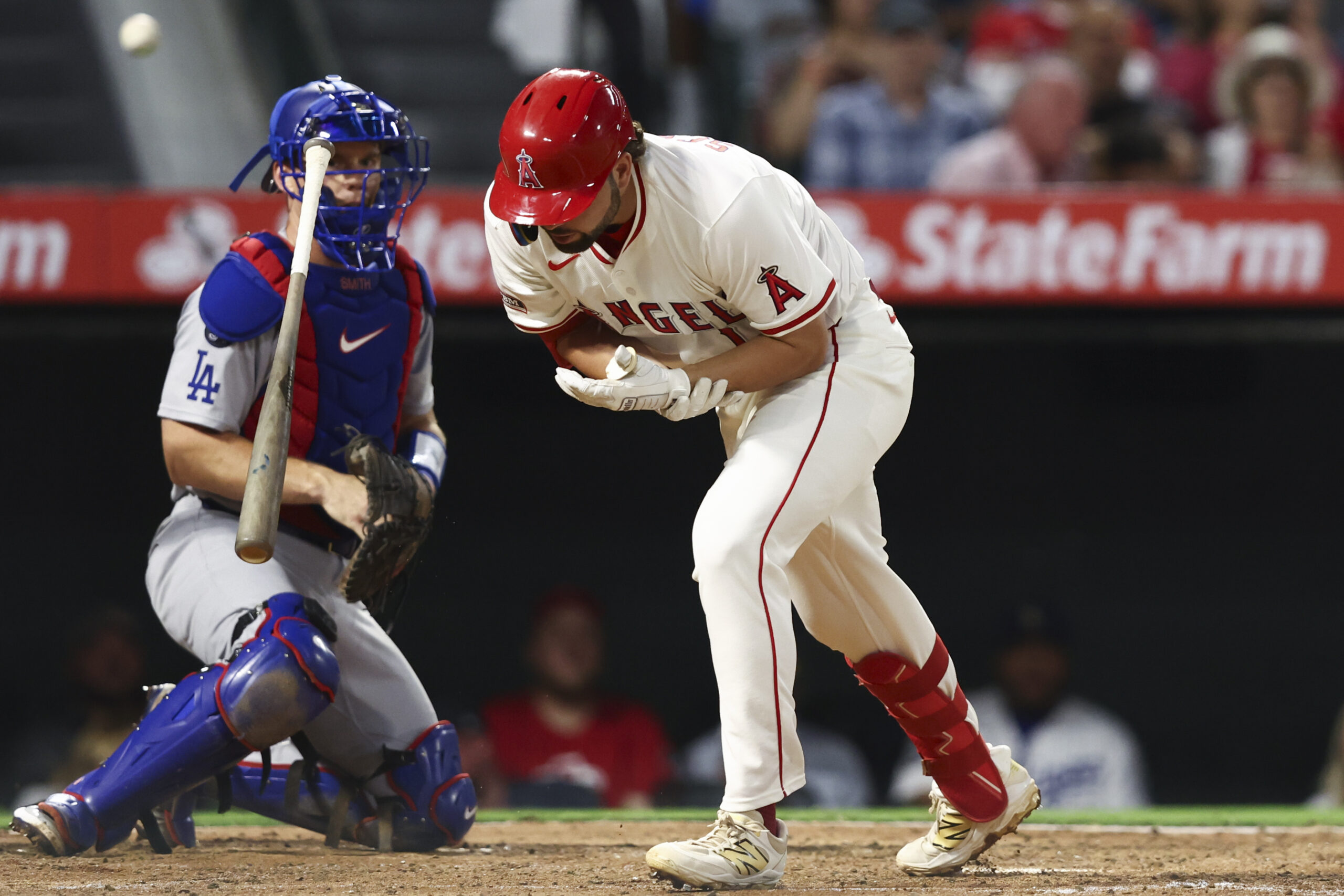 The Angels’ Nolan Schanuel reacts after being hit by a...