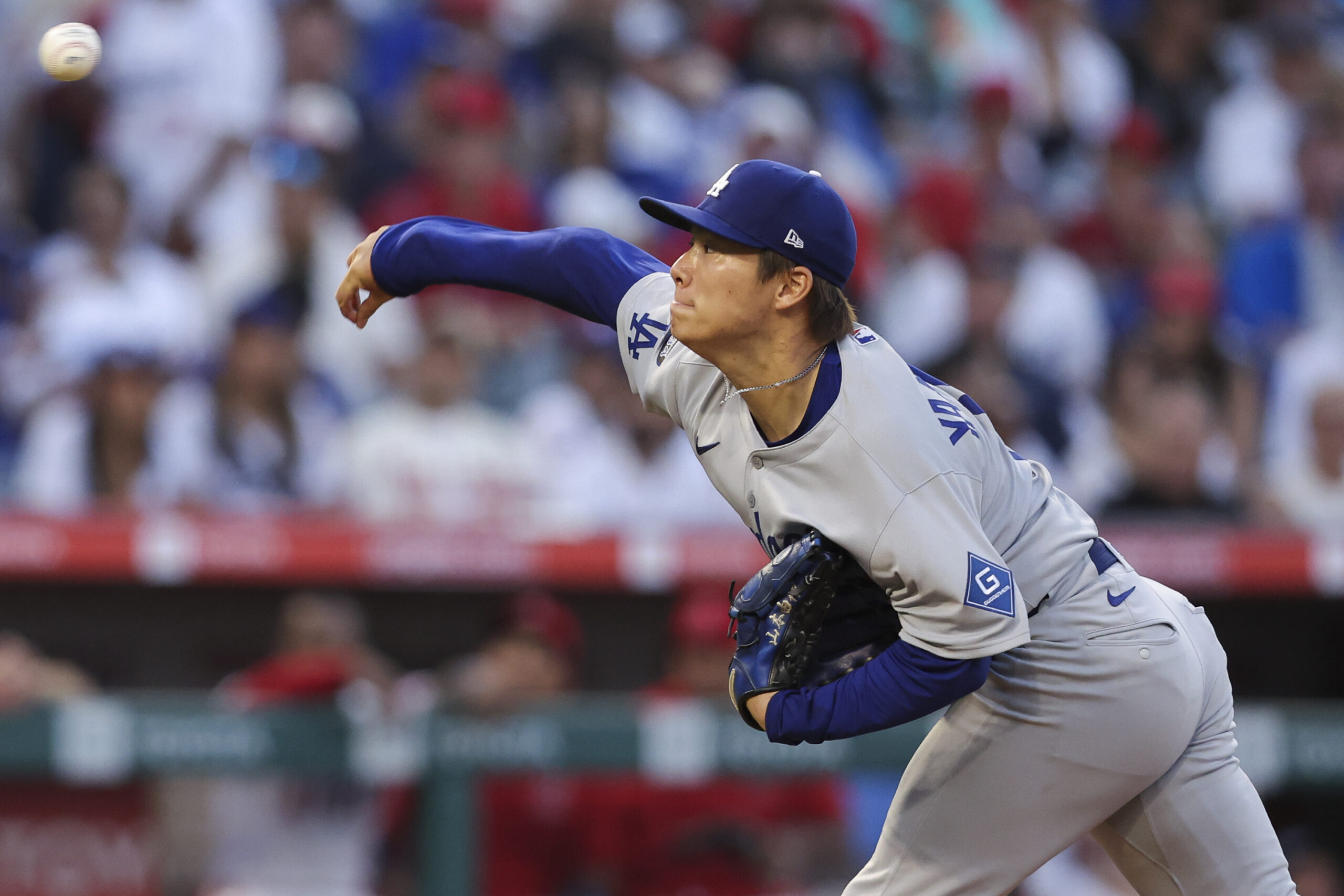 Dodgers starting pitcher Yoshinobu Yamamoto throws to the plate during...