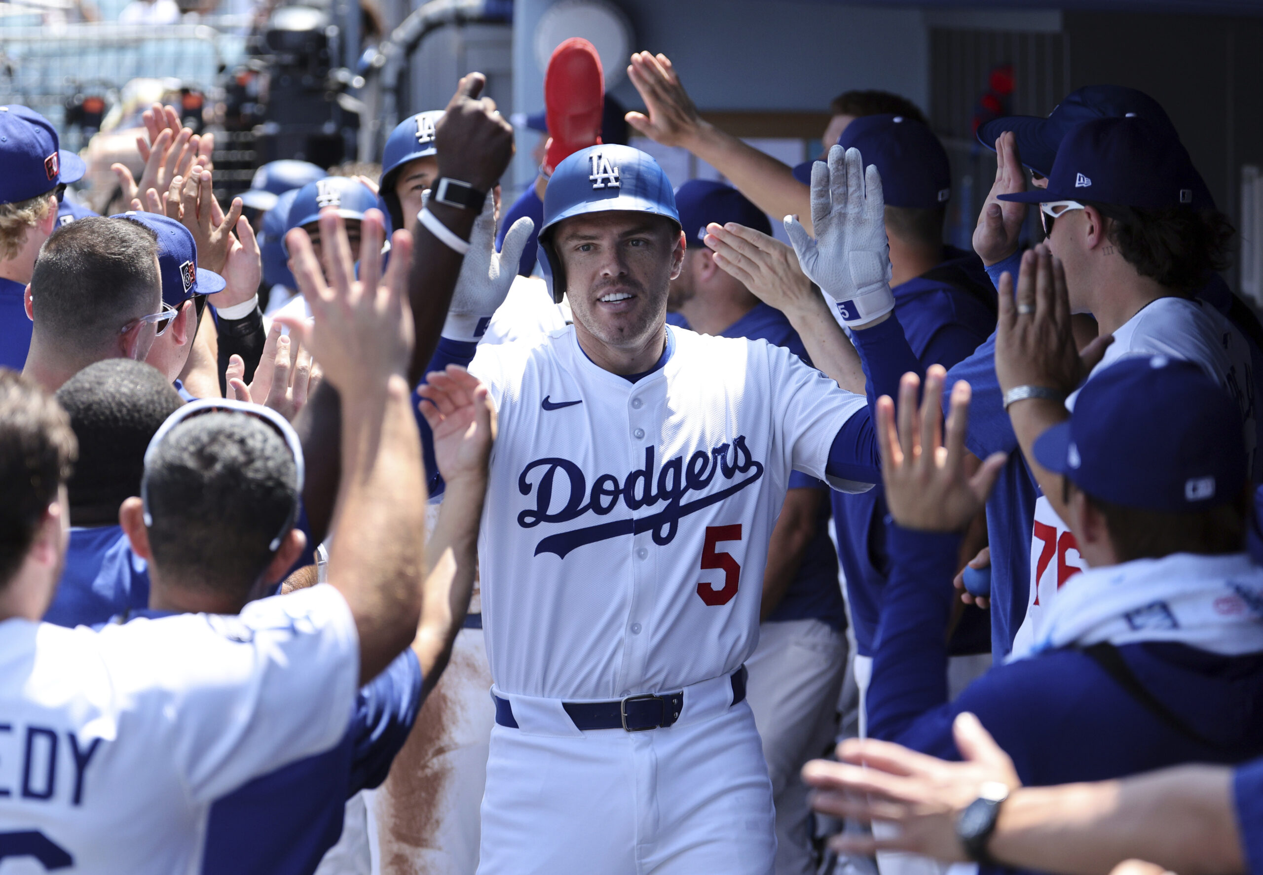 The Dodgers’ Freddie Freeman is congratulated in the dugout after...