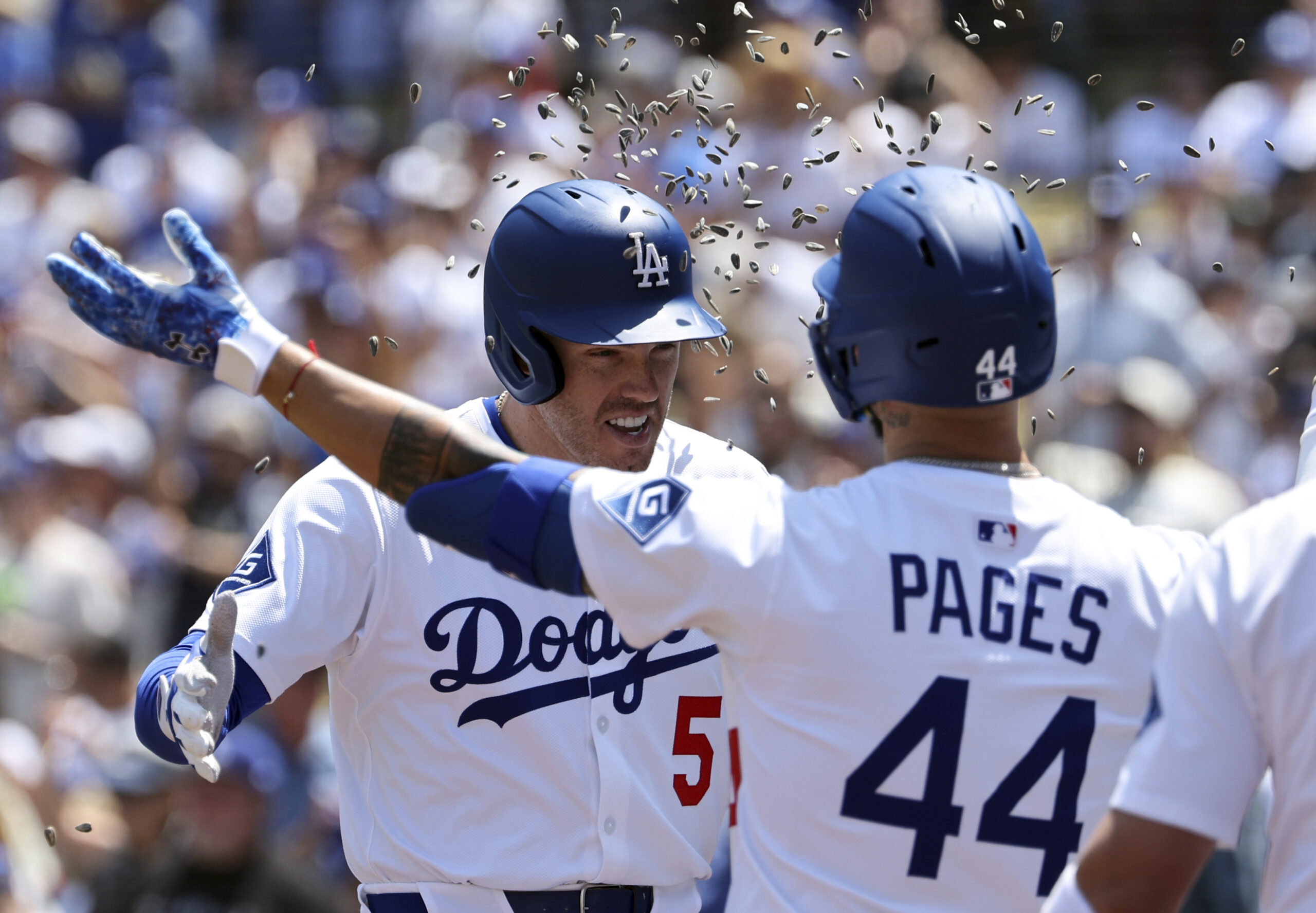 The Dodgers’ Freddie Freeman is congratulated with a sunflower seed...