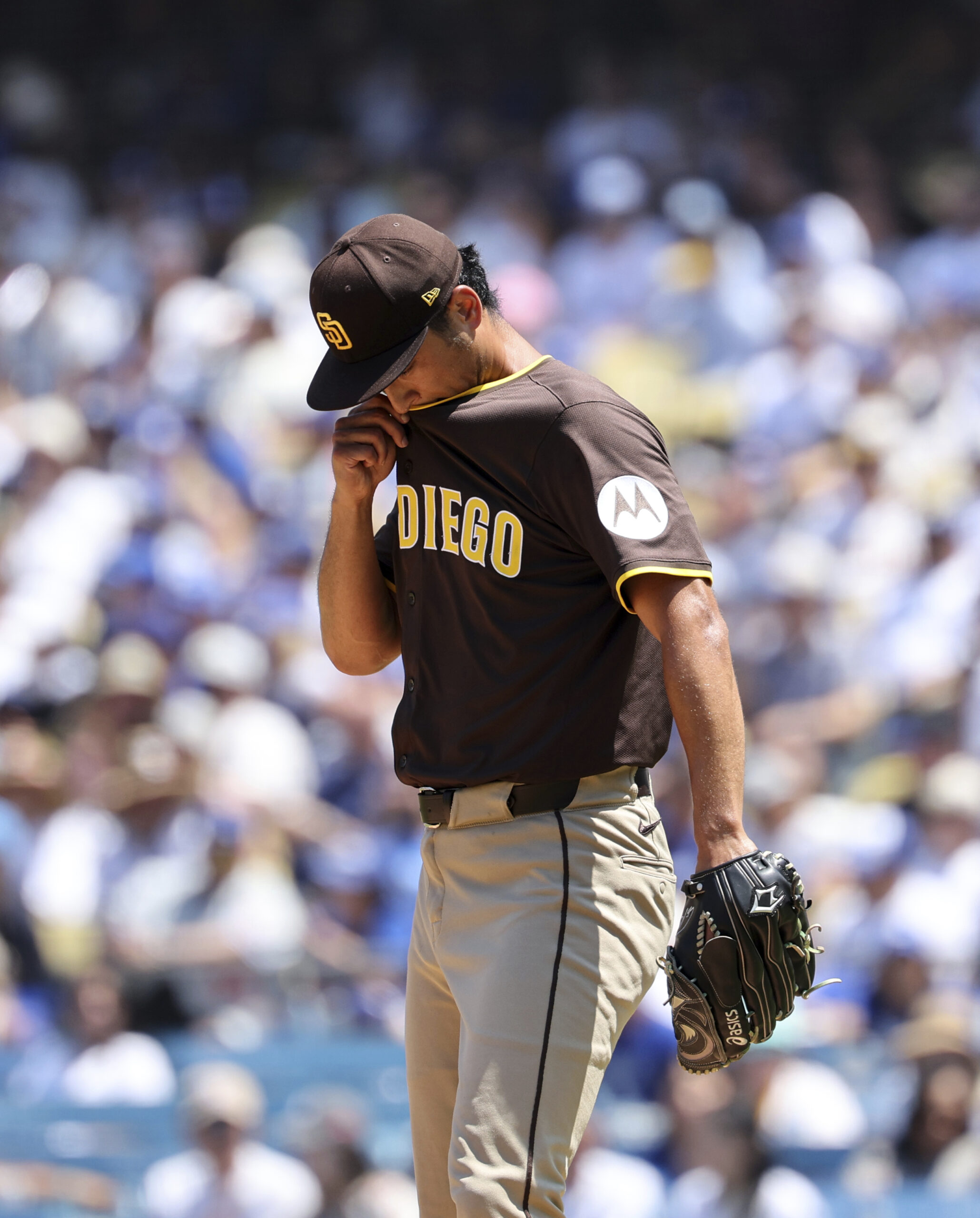 San Diego Padres starting pitcher Yu Darvish wipes his lip...