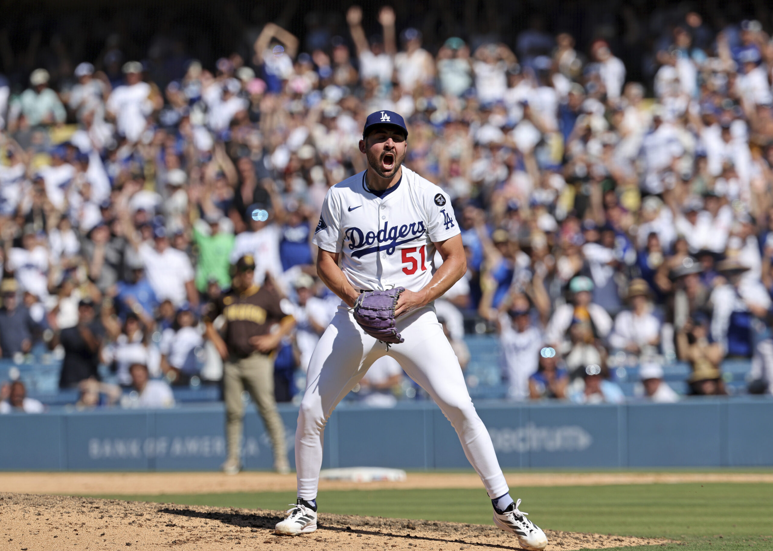 Dodgers relief pitcher Alex Vesia celebrates after striking out the...