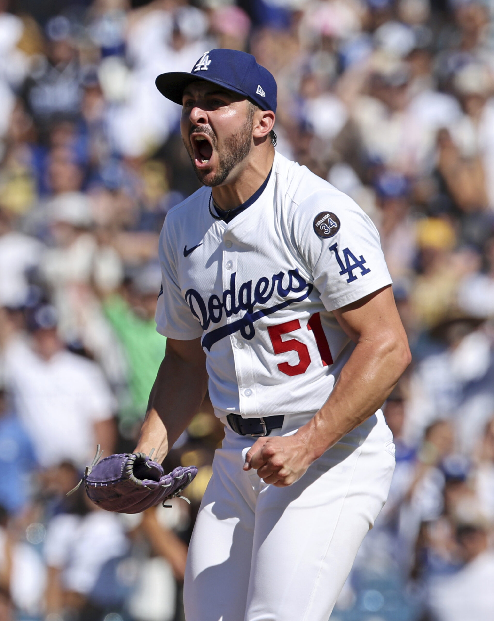 Dodgers relief pitcher Alex Vesia celebrates after striking out the...