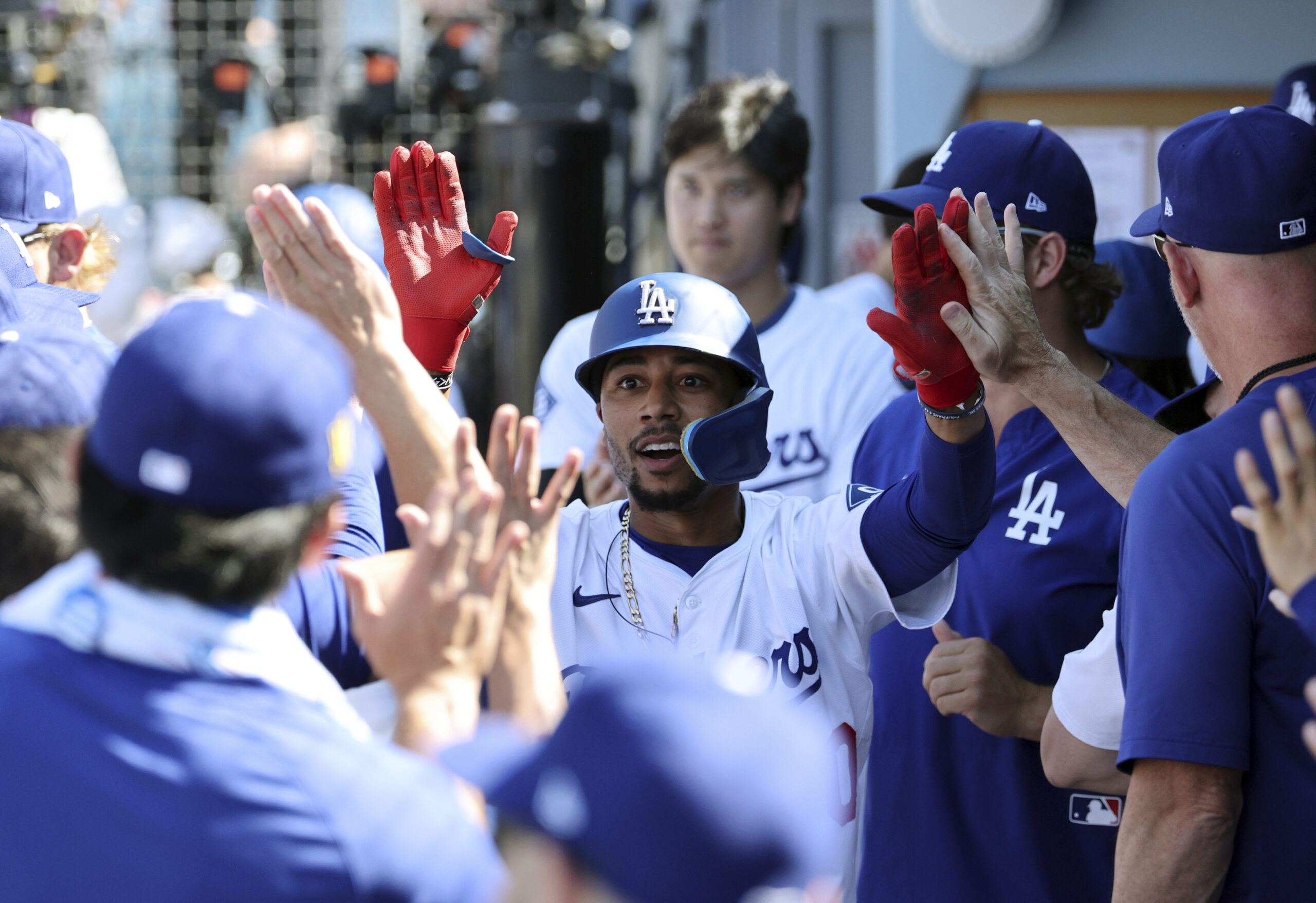 The Dodgers’ Mookie Betts is congratulated in the dugout after...