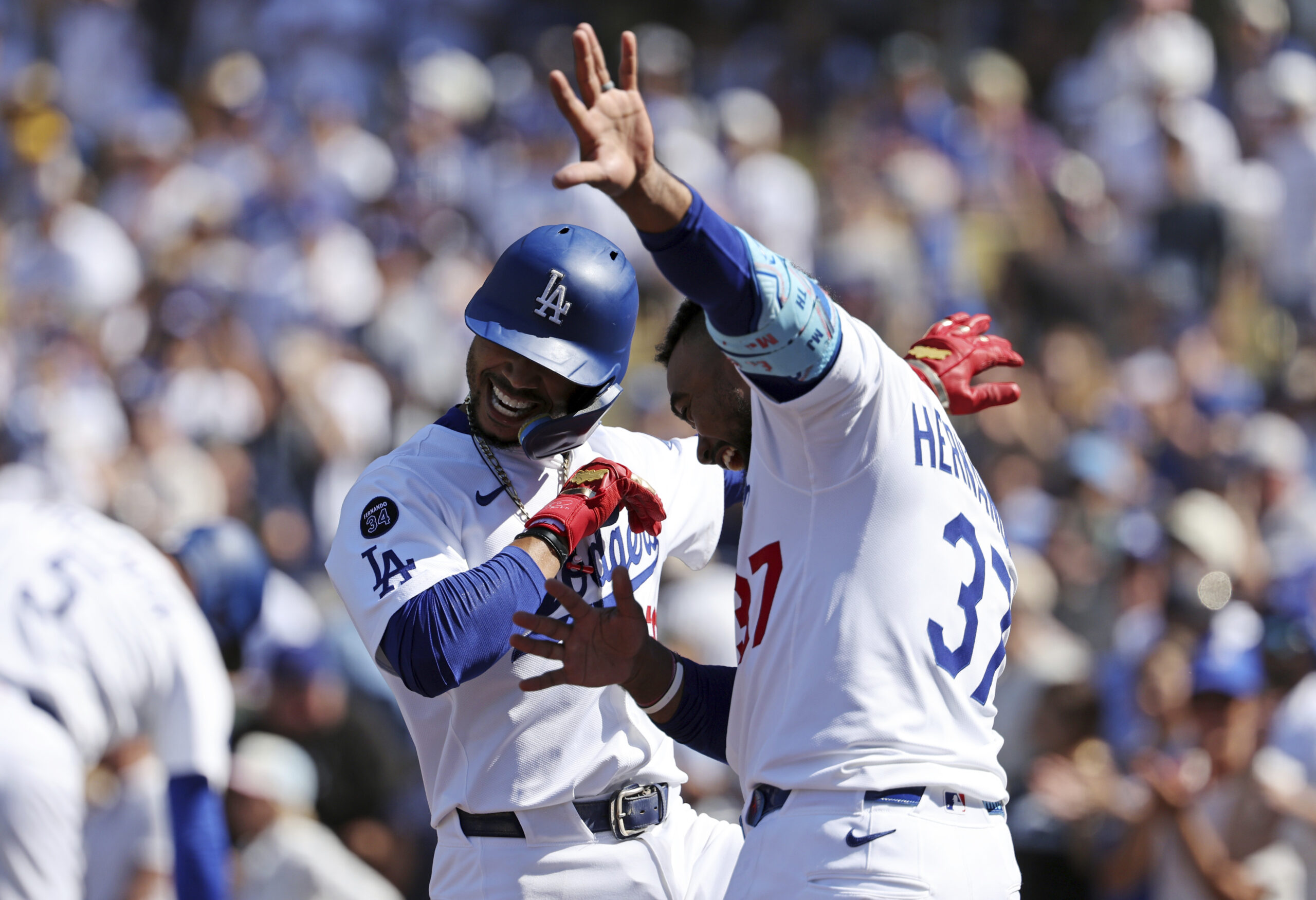 The Dodgers’ Mookie Betts, left, is congratulated by teammate Teoscar...