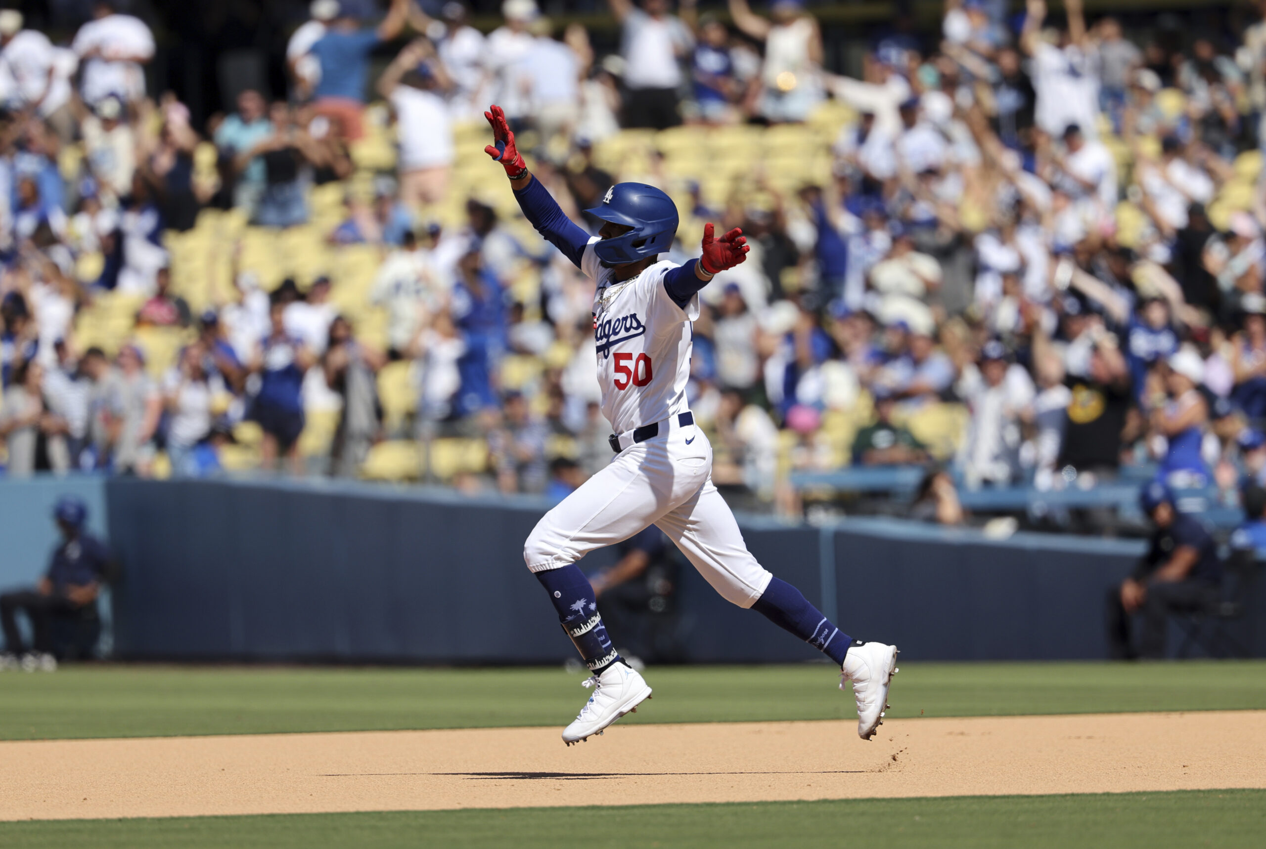 The Dodgers’ Mookie Betts celebrates as he runs the bases...