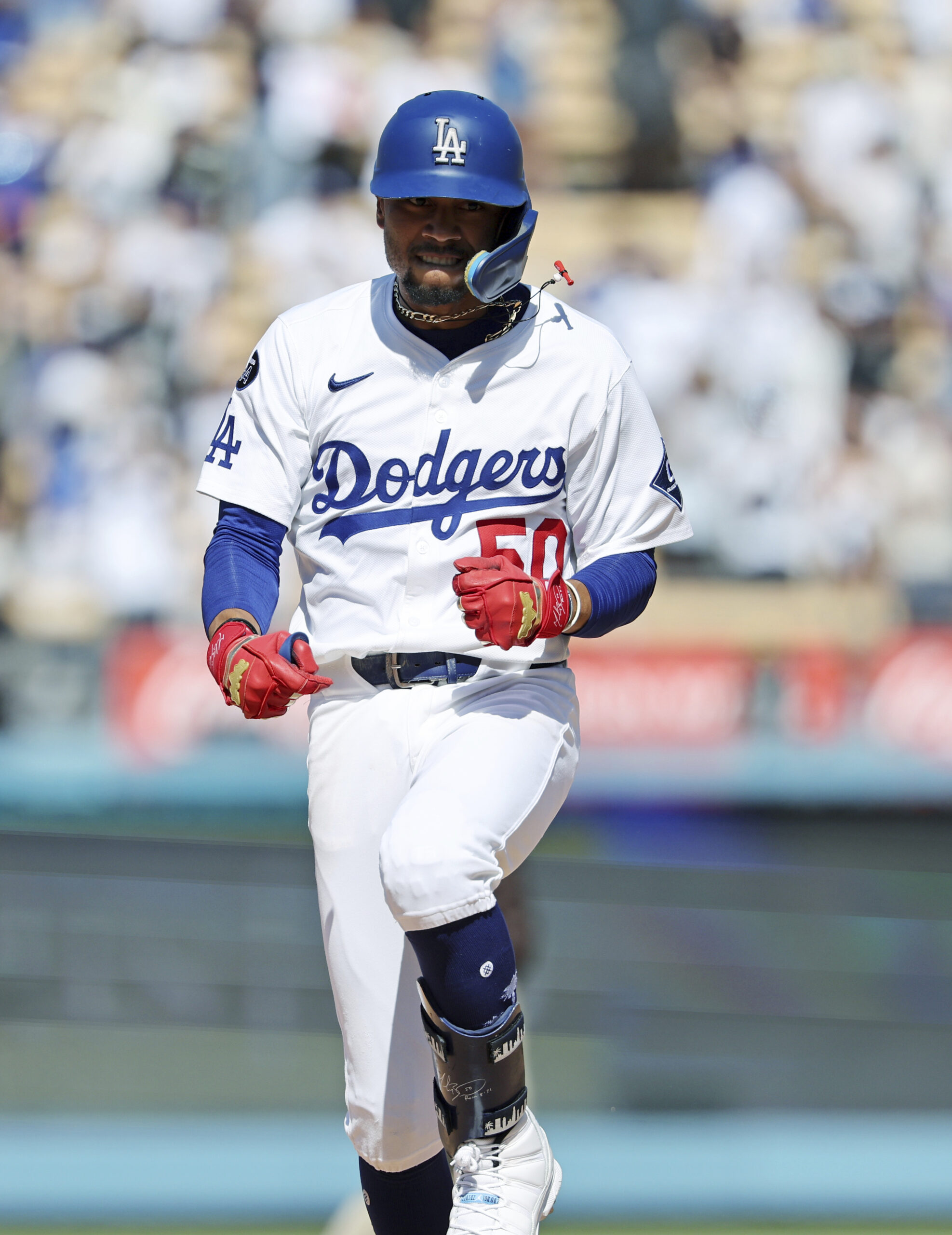 The Dodgers’ Mookie Betts celebrates as he runs the bases...