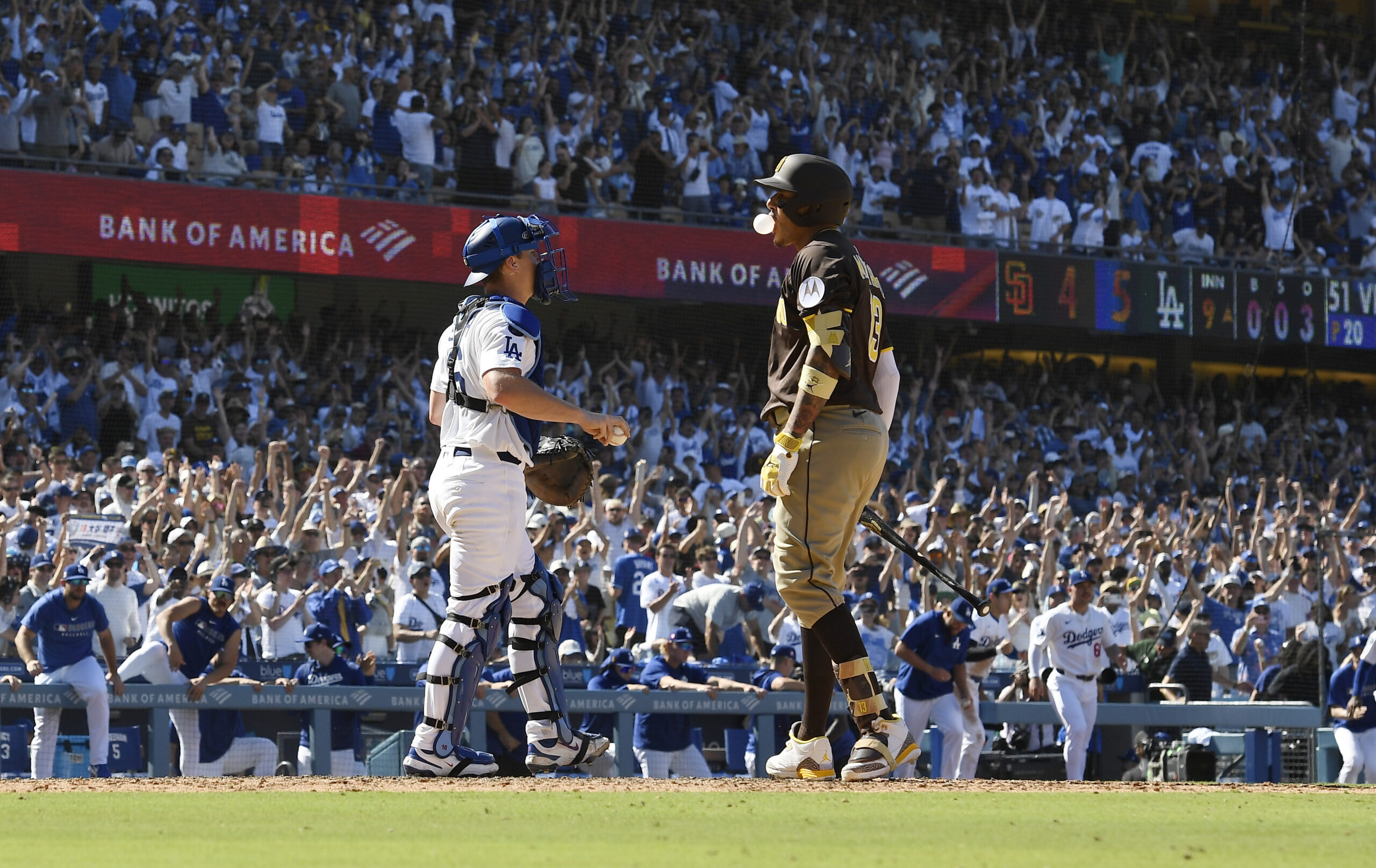 The San Diego Padres’ Manny Machado, right, reacts after striking...